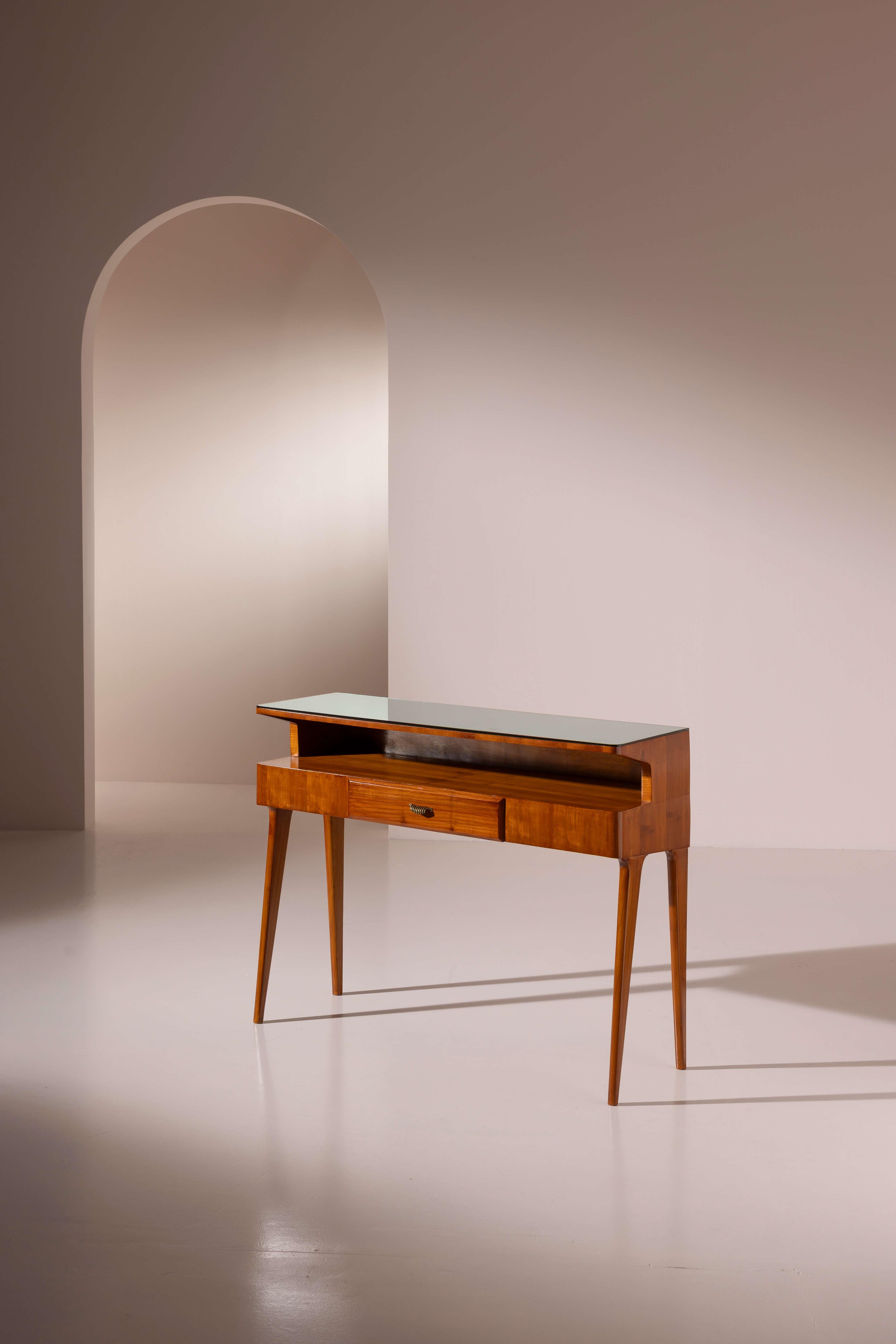 An elegant and well-proportioned cherrywood console table with drawer and glass top, Italian manufacture, 1950s

Which corner of your home could welcome this charming piece? Perfect for an entryway, hallway, or as an occasional table in a living