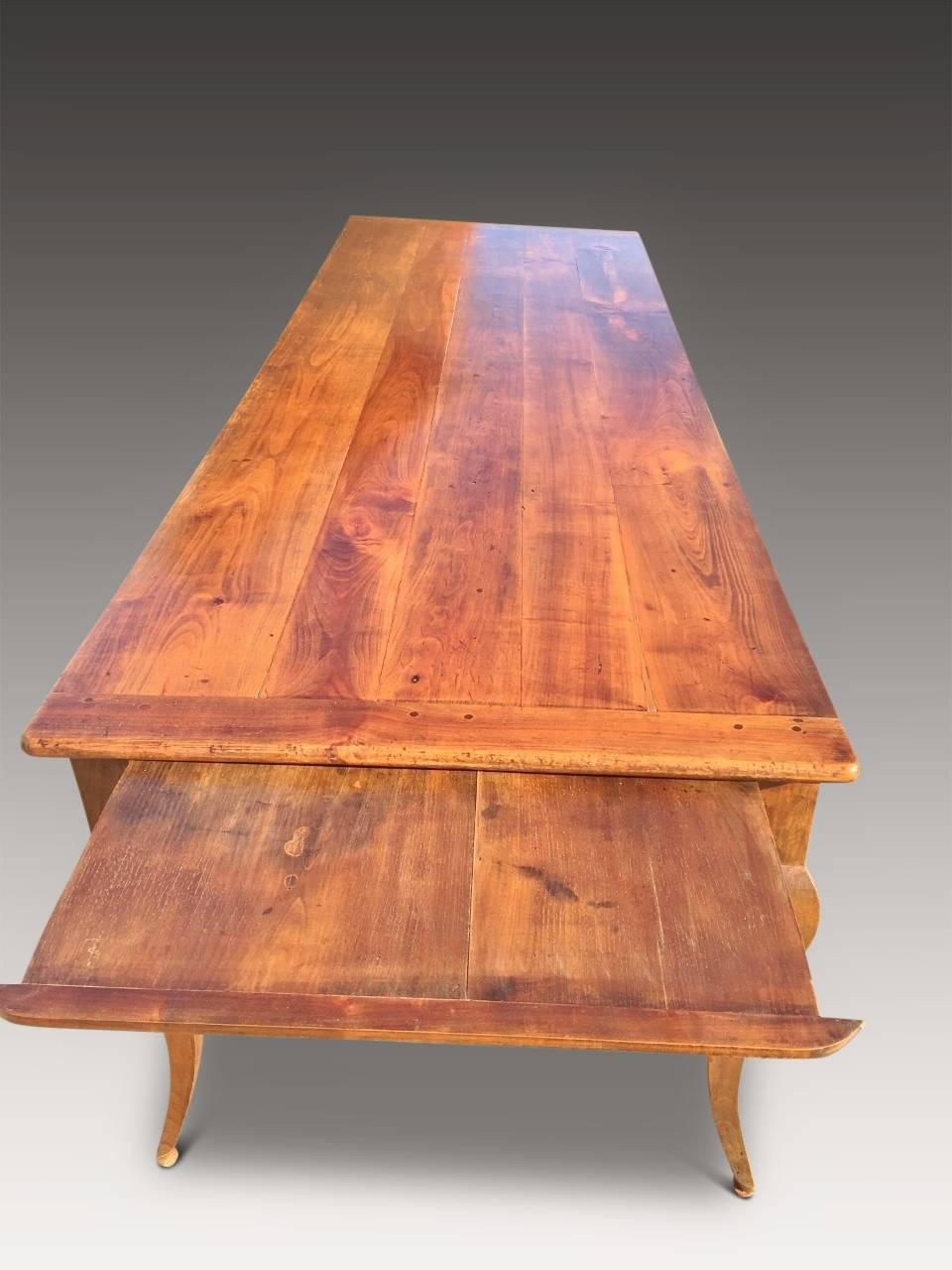 Fabulous large French cherry wood dining table, dated to about  1860. It seats 10 to 12 people comfortably and has plenty of elbow and leg room with a floor to apron height of 24.5 inches. Every joint is firm and sturdy and the top is level and