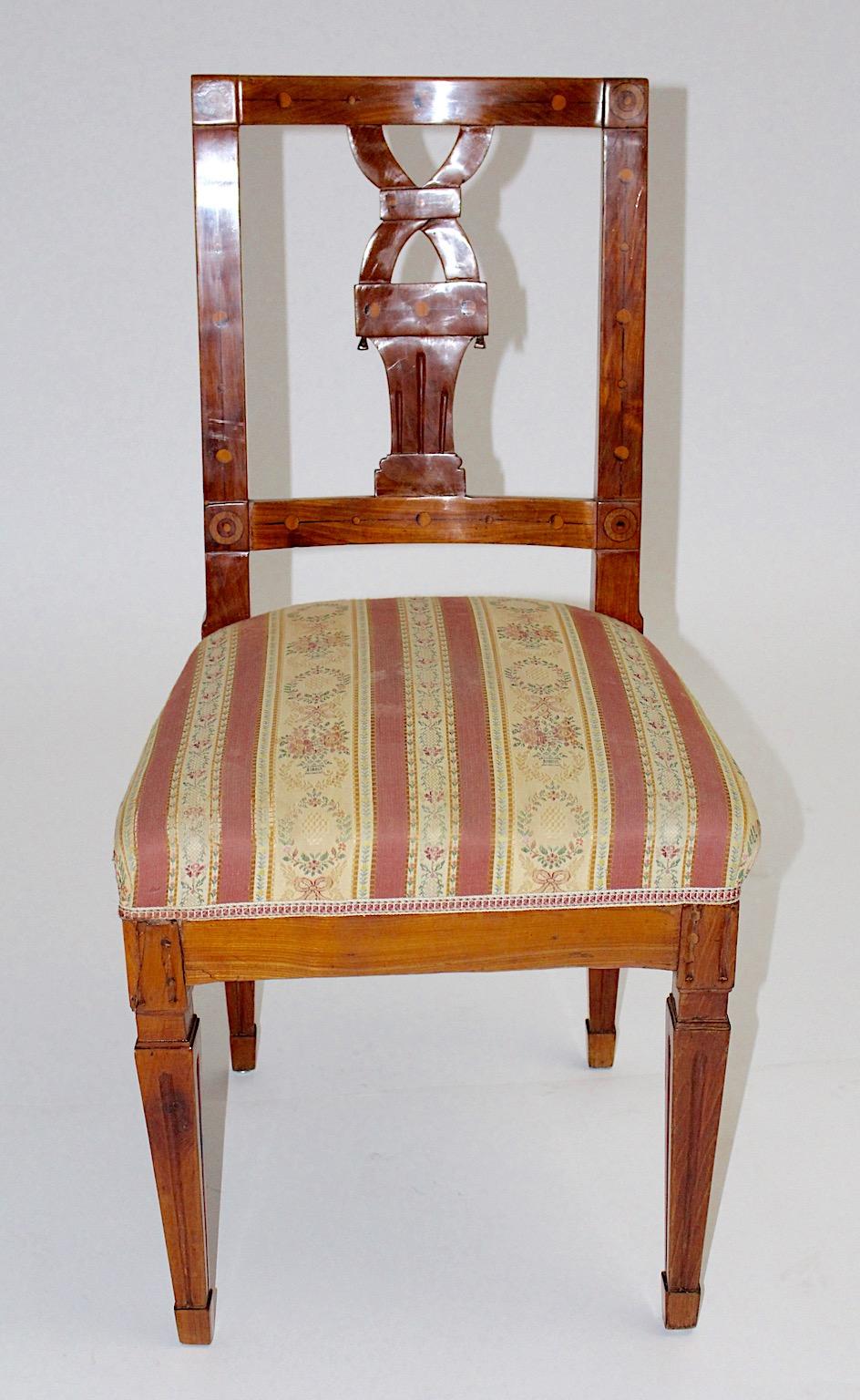 Dining chair or side chair hand carved solid cherrywood with maple inlays circa 1780, Austria. 
The Josephinische Stil was a popular style in Austria in the 18th century.
This style marked the end of Habsburgerbarock and corresponded to the start