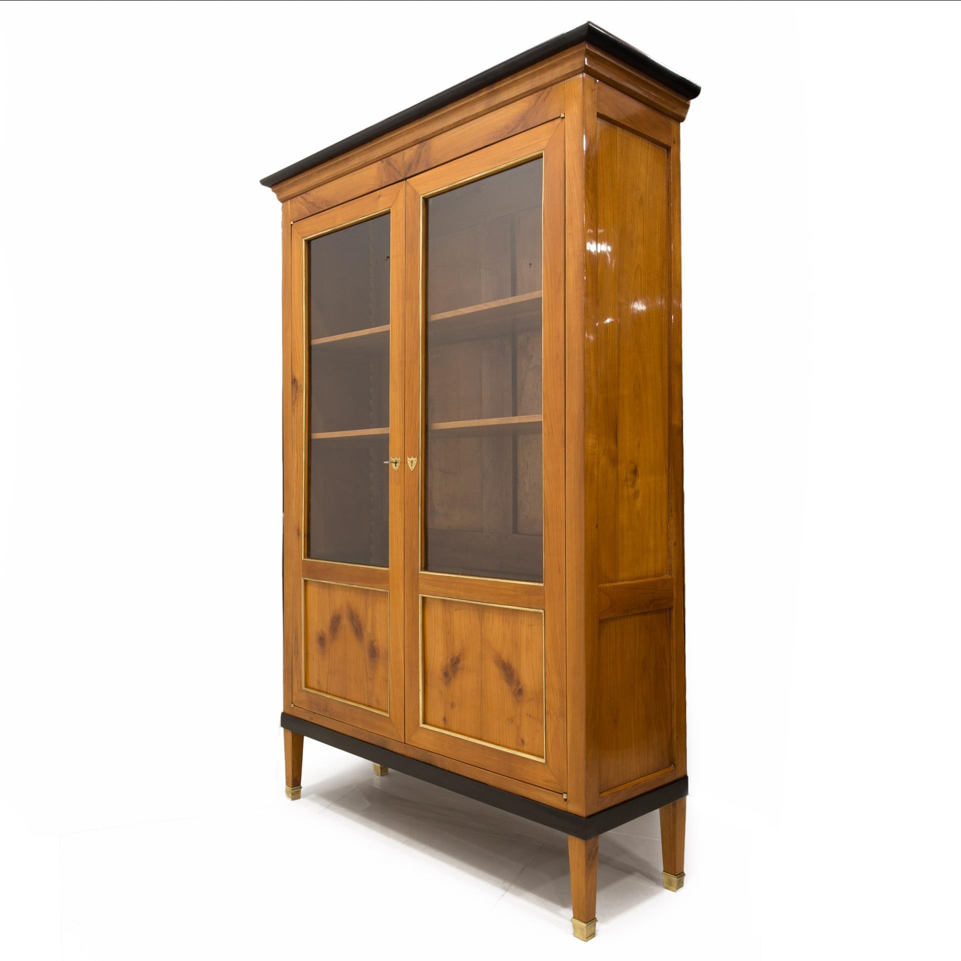 This beautiful cherrywood vitrine comes from Germany from 19th century (the Biedermeier period). The construction is made of solid cherrywood. The piece features practical shelves with adjustable height system. It was professionally renovated,