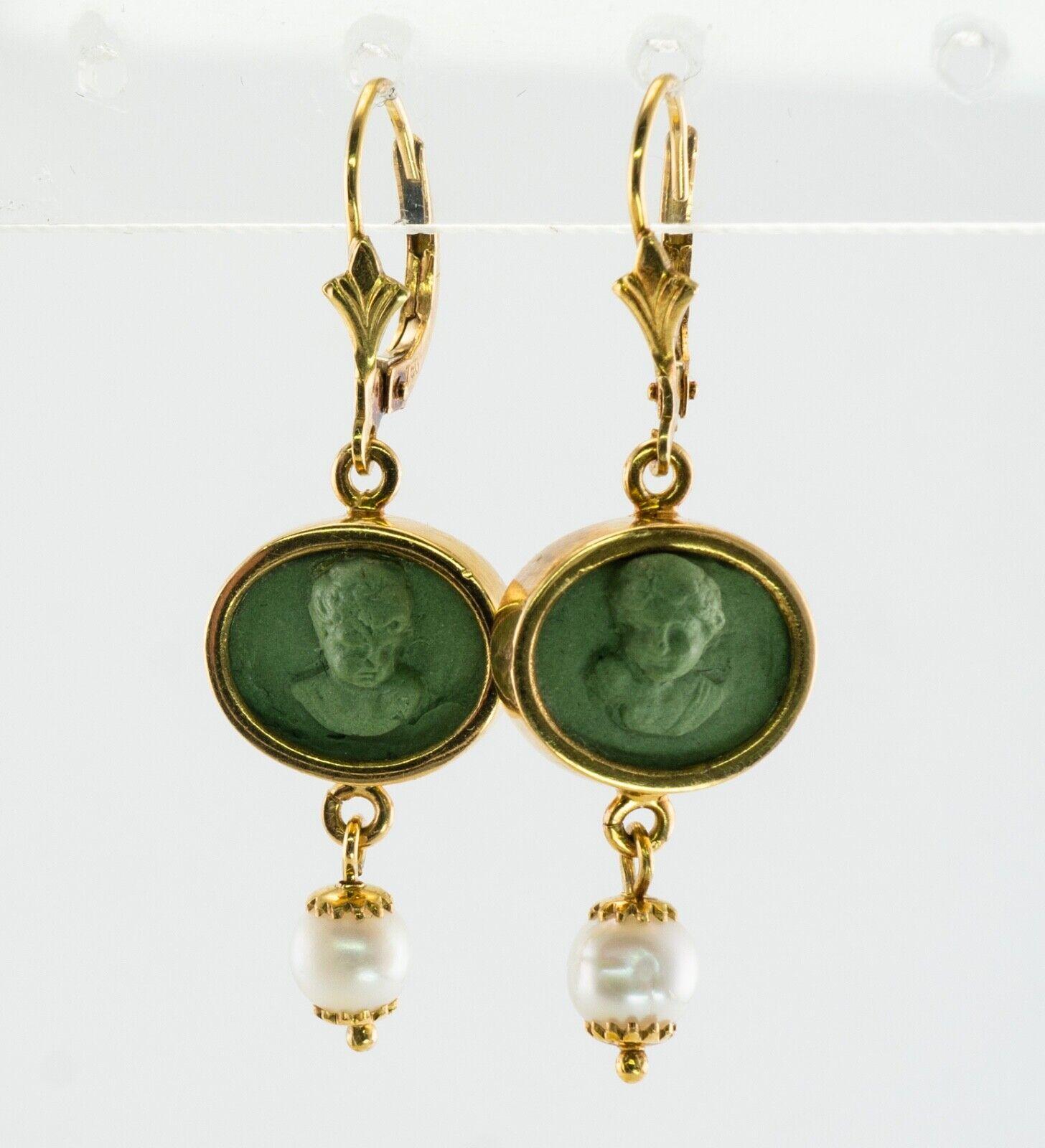 This gorgeous pair of earrings is finely crafted in solid 18K Yellow gold, they also have a hallmark. Green volcanic Lava high profile cameos depict the head of cherubs or angels. They are highly detailed and very well made. The bottom dangling part
