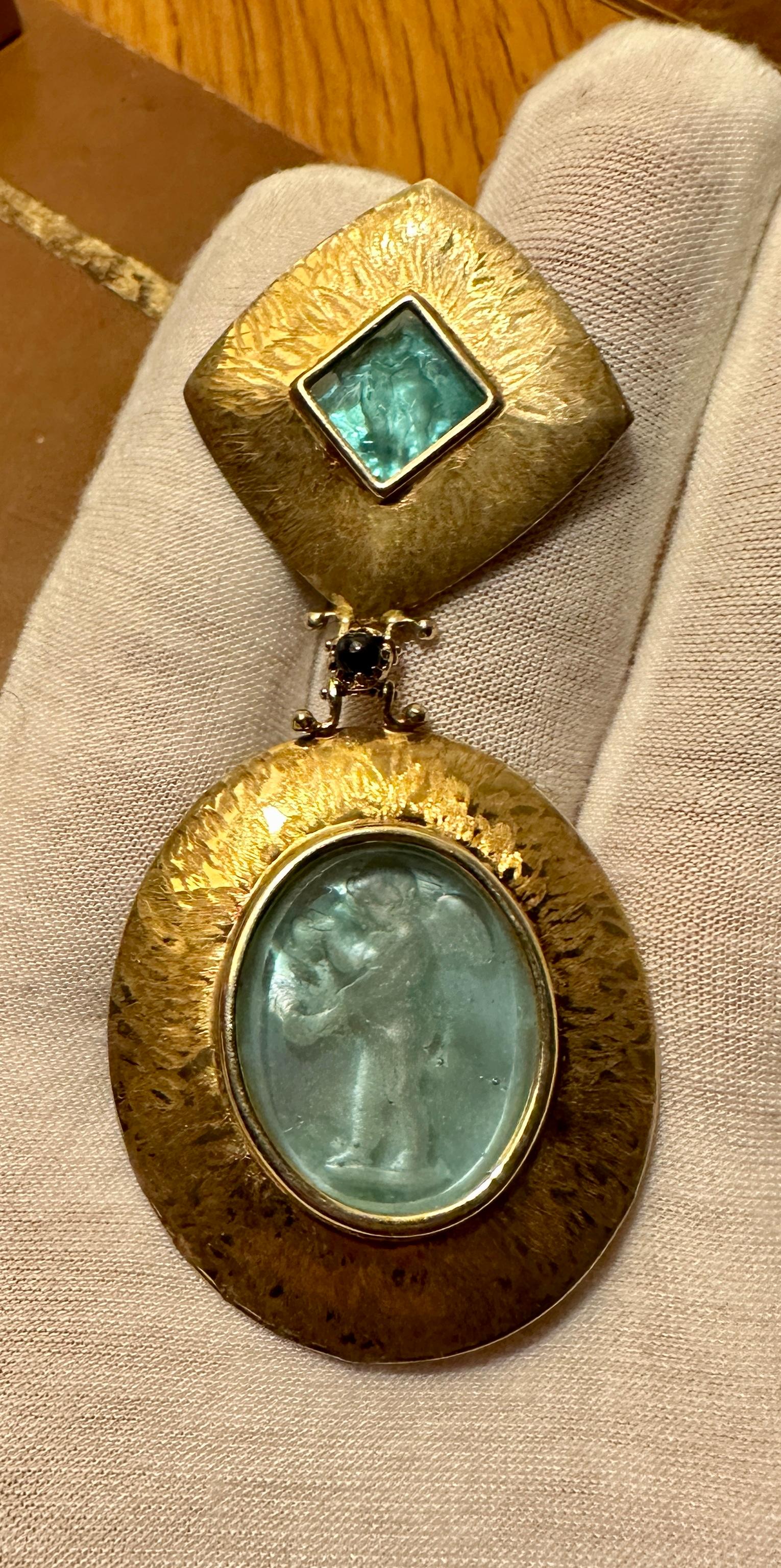 Indulge in this magnificent Cherub Intaglio Pendant in 14 Karat Yellow Gold and Topaz.  The exquisite Venetian Glass Intaglios are in the perfect Sea Foam Blue - Green color.  The double intaglios are set in gorgeous 14 Karat Gold.  The pendant is a