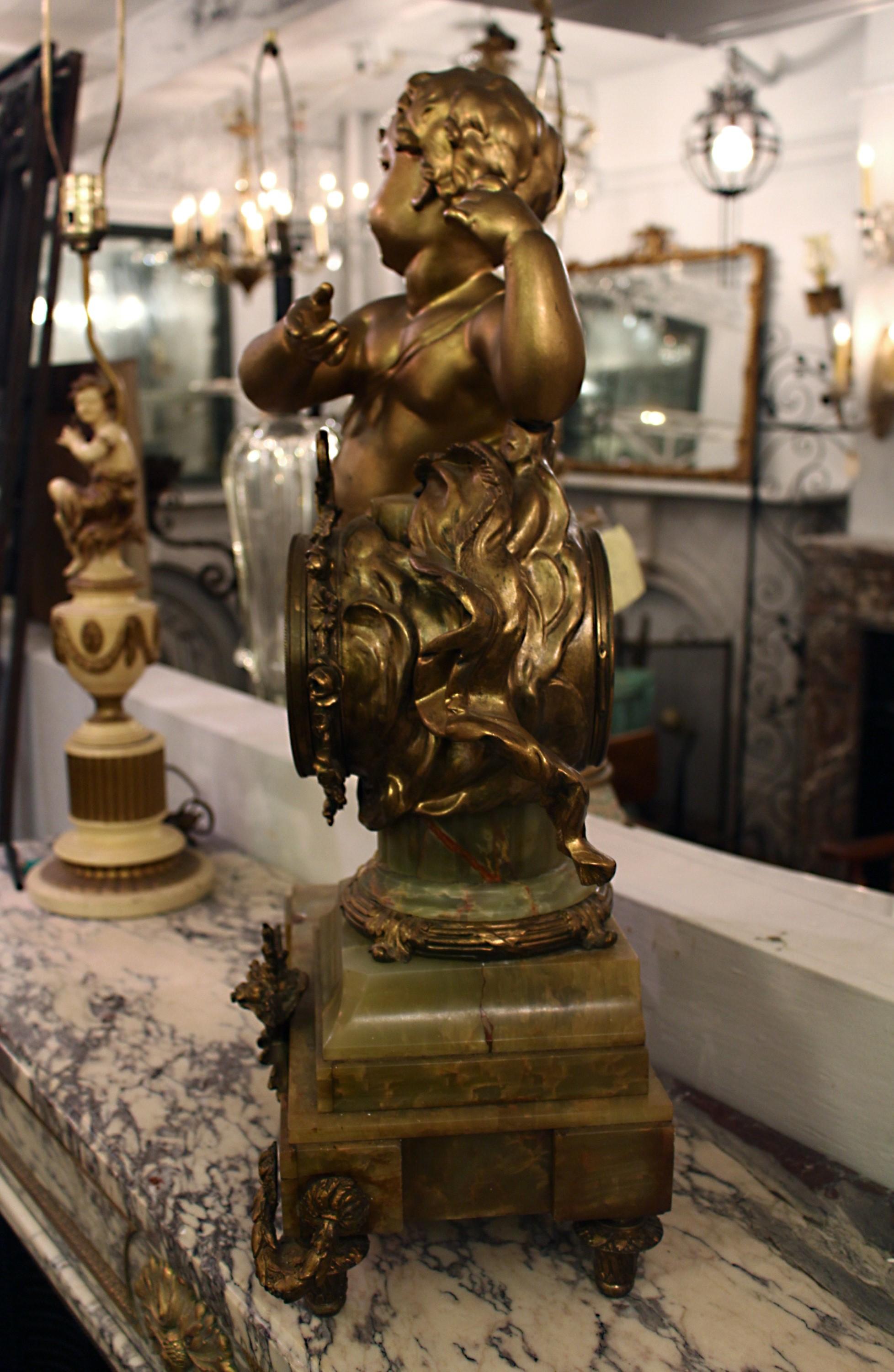 Decorative French bronze mantle clock on an onyx base with a large spelter Cherub. The clock is in need of repair. Priced as is, considering its current condition. Please note, this item is located in one of our NYC locations.