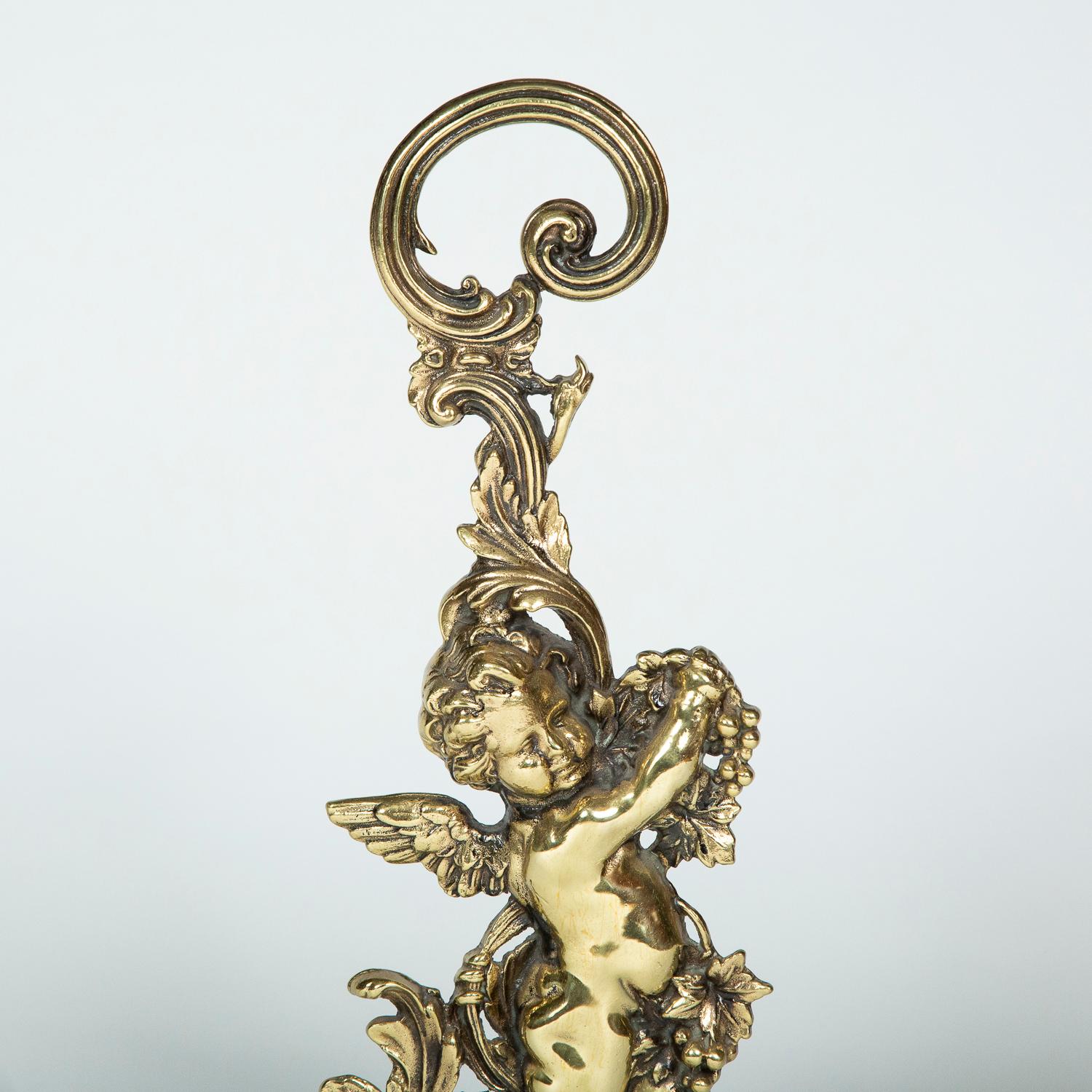 A brass door porter in the form of a cherub. 

With iron weighted base, marked: PEERAGE ENGLAND 4570.