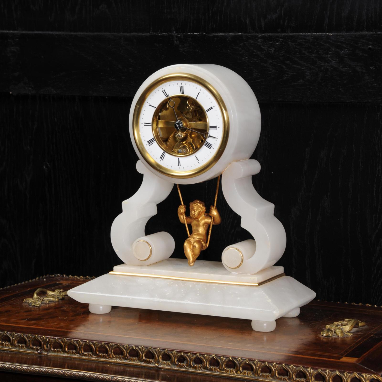 A super, rare original antique French clock featuring a cherub swinging back and forth as the pendulum. This is the Farcot version, the best one, patented by Farcot in 1862. It uses a double escapement with a half moon pallet to achieve the front to
