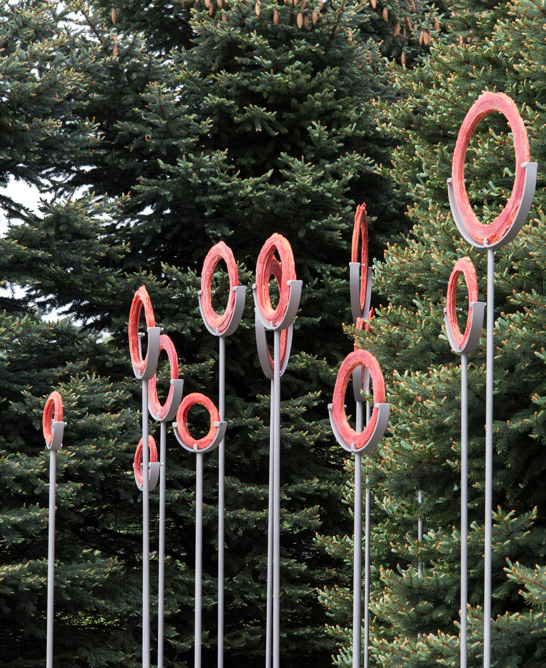 This contemporary red glass and steel outdoor sculpture is by Canadian artist Cheryl Wilson Smith.

Cheryl Wilson-Smith takes daily one-hour walks in the ancient boreal forests that surround her home in Red Lake, Ontario. Her beautiful glass frit
