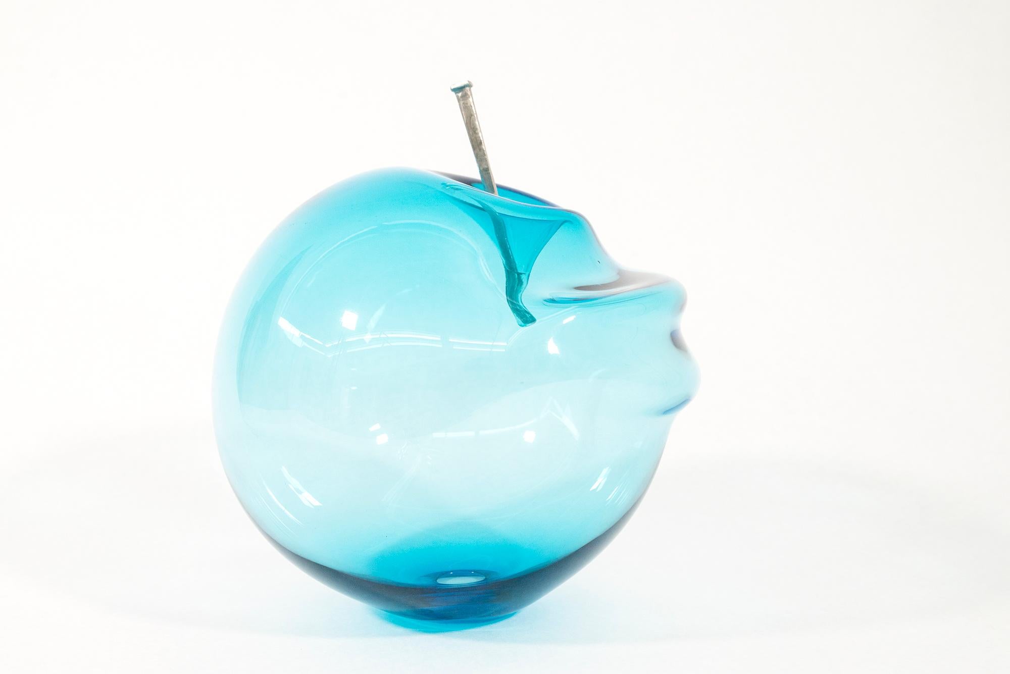 This contemporary blue glass tabletop sculpture is by Cheryl Wilson Smith.

Cheryl Wilson Smith is known for her uniquely beautiful glass work—its form, color and texture is often inspired by the rugged natural beauty of her home and studio in