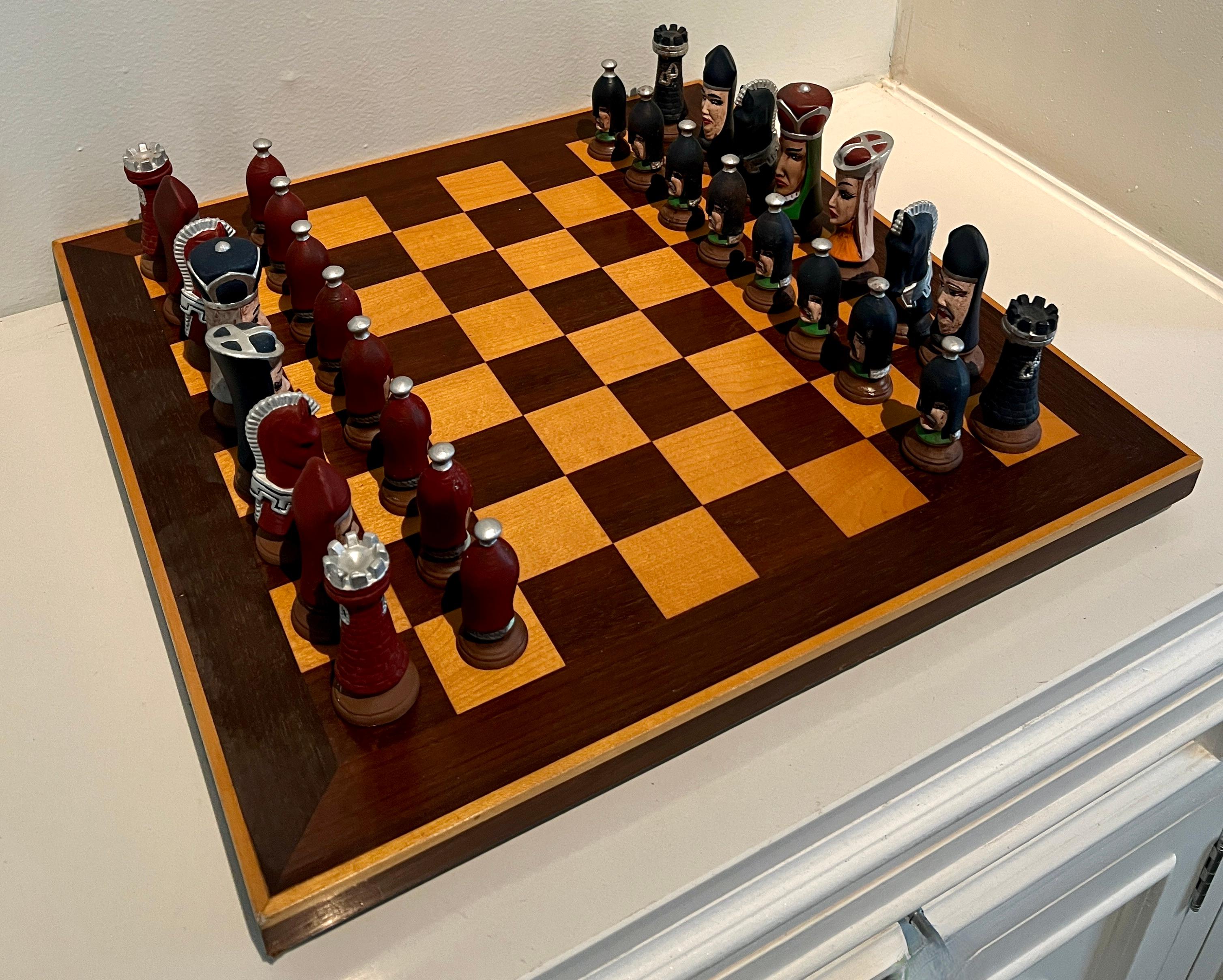 Solid Wood Chess Checker Board with small raised feet and underside felt lined.

Accompanied with hand made Ceramic Chess Pieces by Sally Anderson - in very good vintage condition.  A compliment to any space.  Can be pulled out for special occasions