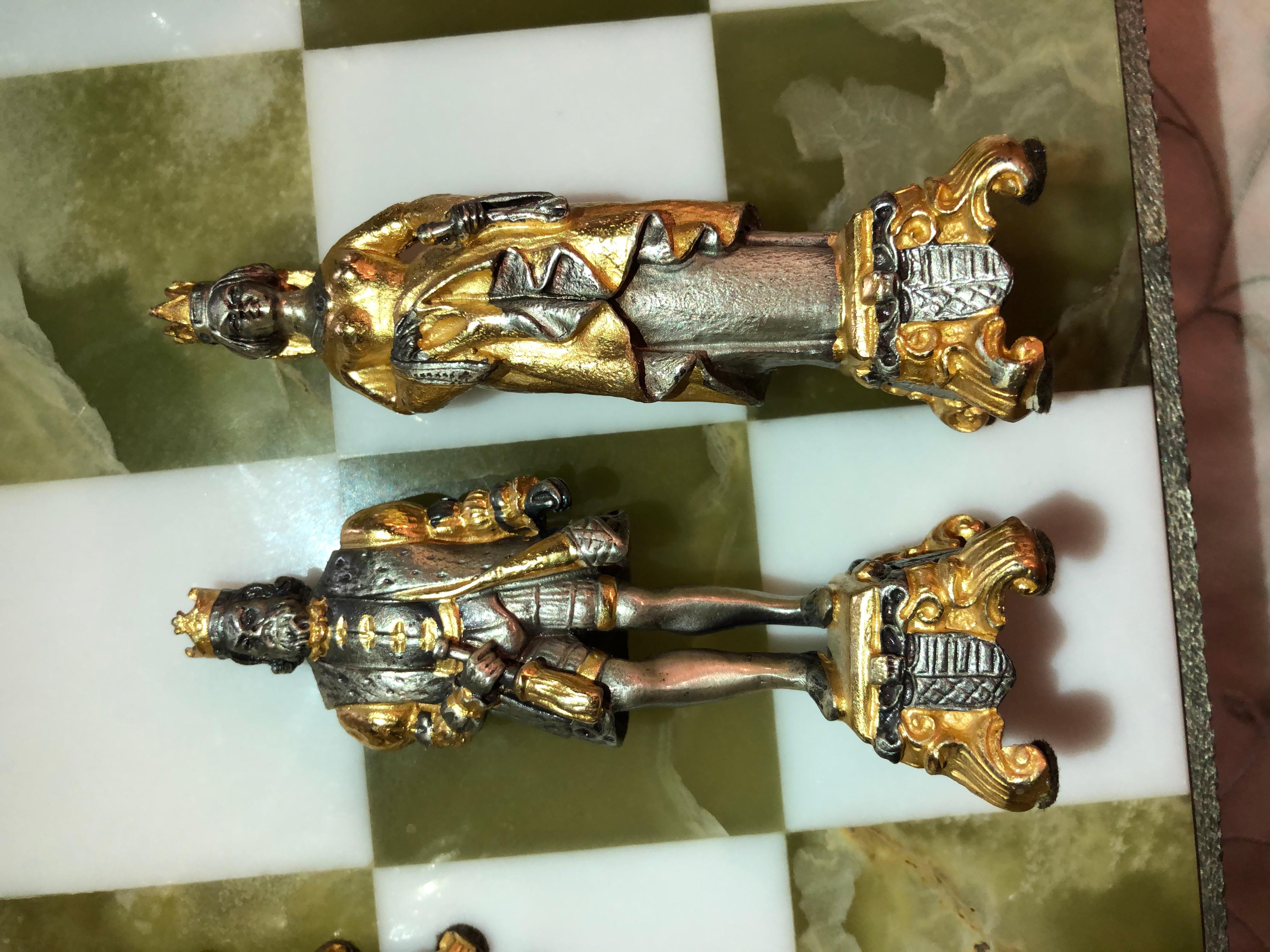 Purchased at the shop Ruby Gallery on the Grande Canal, Venice Porte Rialto Bridge in 2003 bronze cast with Vermillion gold and silver finishes. The chess board is made of green and white onyx finished in a bronze frame surround having gold and