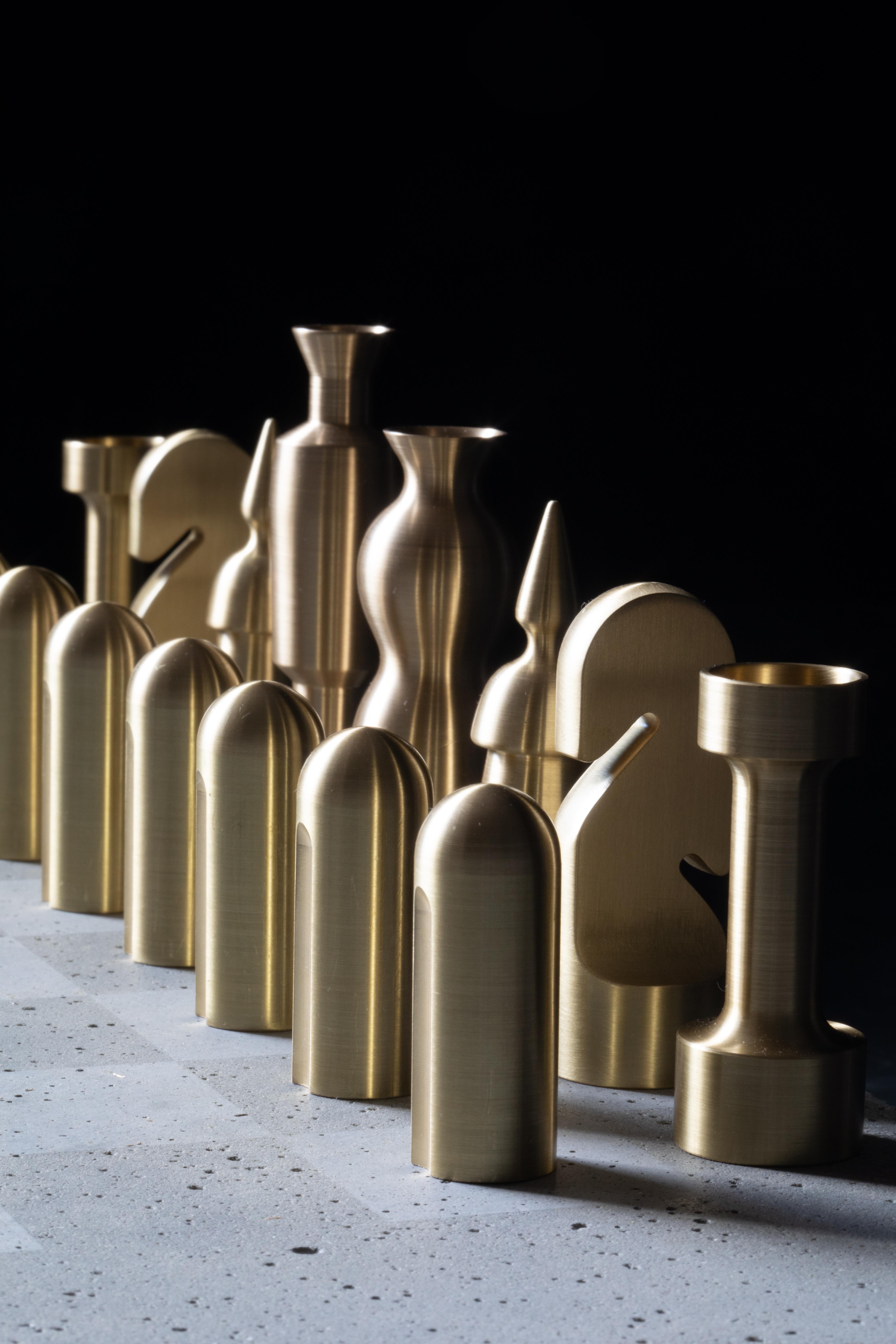 A bronze and cast concrete chess set. The chess pieces are machined from solid bronze bar and half the pieces are then blackened with hand applied patina.