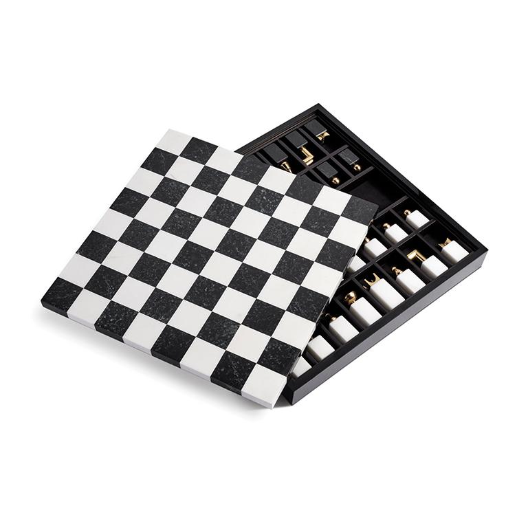 Boasting materials such as lacquered Macassar ebony wood, marble, brass and shell inlay, this handsome chess set will become the focal point of the room. Marble and brass chess pieces are abstract interpretations of the iconic movable