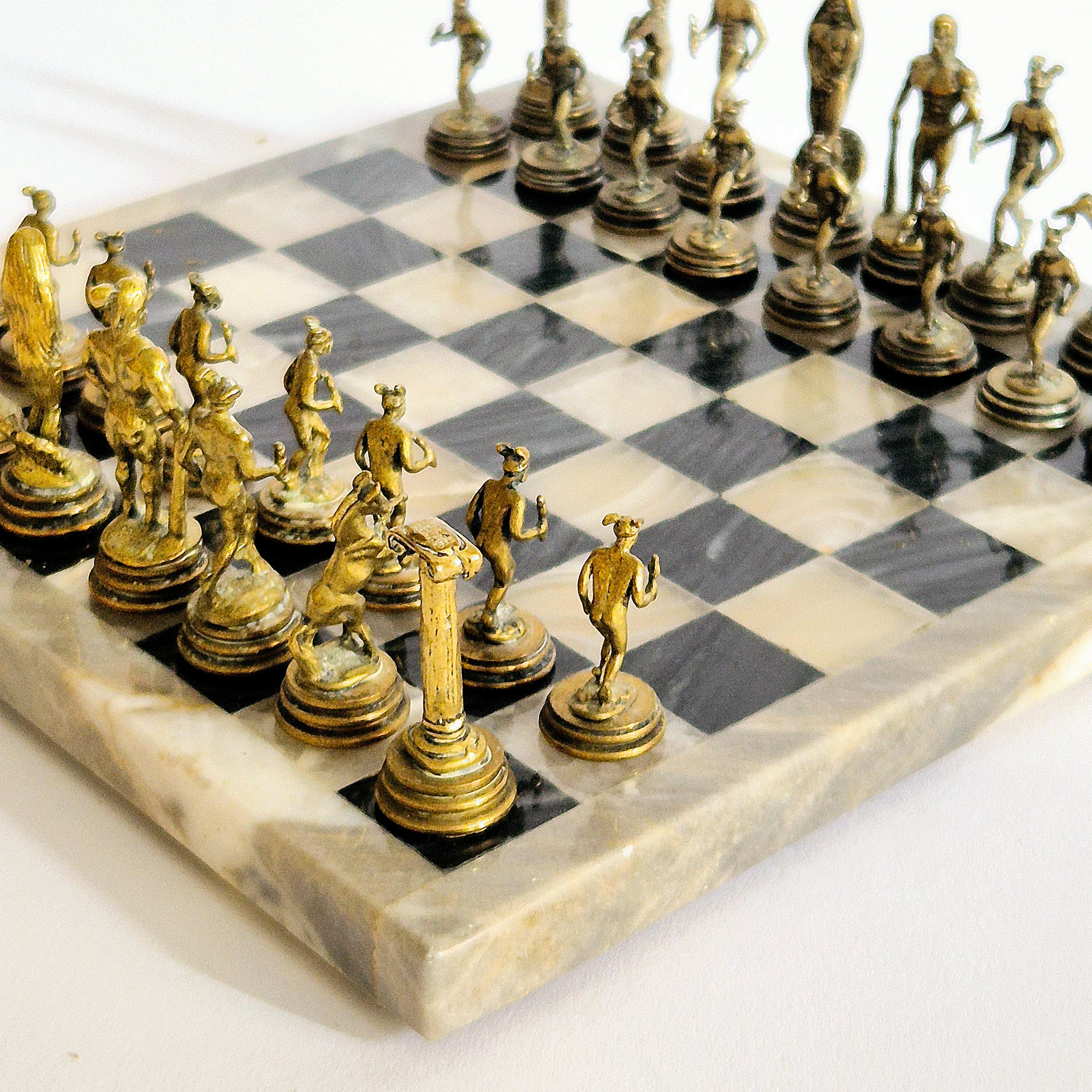 A rare chess set in onyx with players in pewter and gold colored finish. Decorative, sculptural set with nice patina. 

