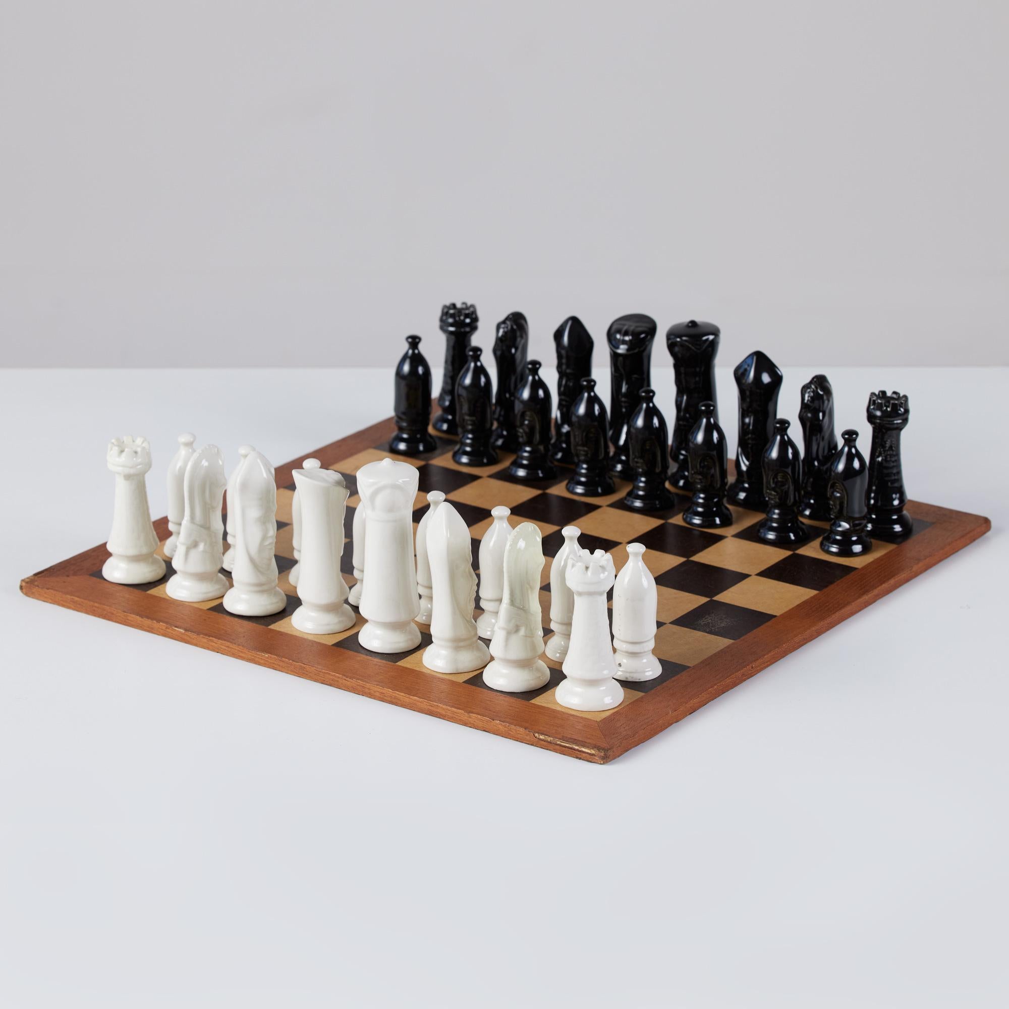 This stunning set features a black and tan wood checkerboard with walnut trim. It is paired with hand made ceramic glazed black and ivory chess pieces.

Dimensions
Board: 16” width x 16” depth x .25” height.

Chess pieces: 4