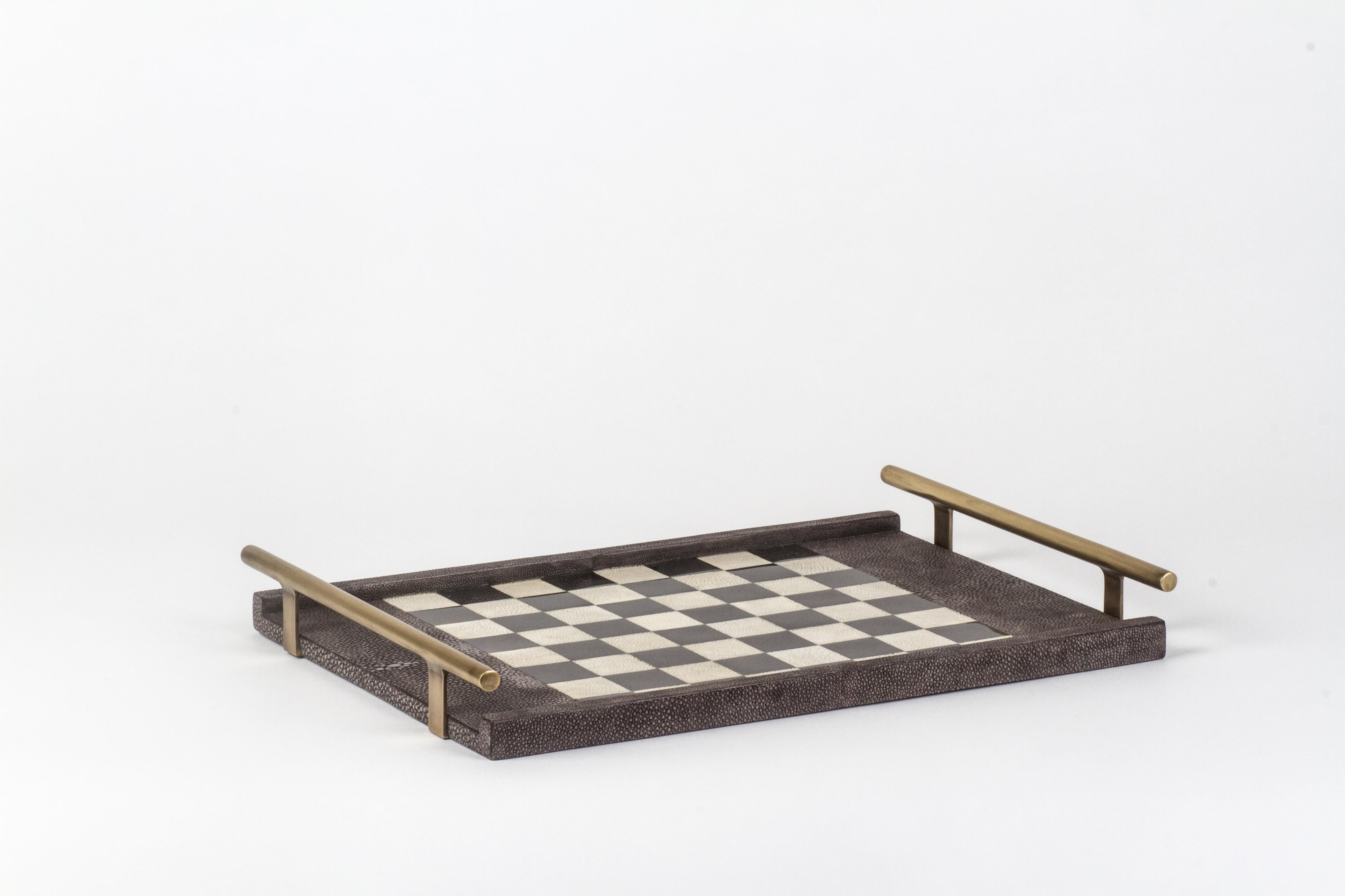 The KIFU PARIS chess game tray is the ultimate luxury game. Accented with a mixture of shagreen, pen shell and bronze-patina brass this piece comes with all game parts in a velvet pouch. Available in a light or dark color-way.

The dimensions of
