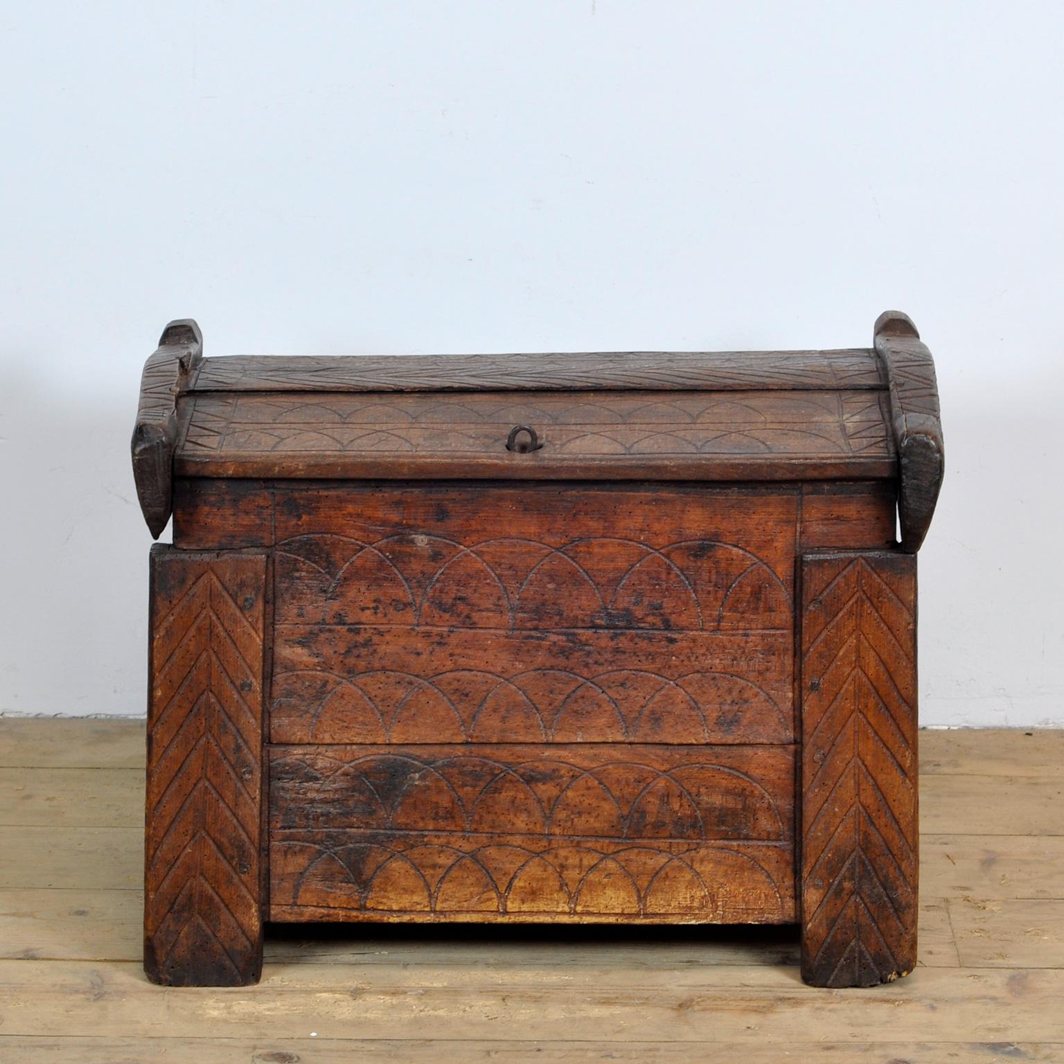 Hardwood chest from Moldava, circa 1800. The chest is decorated on the outside with carvings. 
The chest is free of woodworm. Over the years the two back legs became a bit shorter.
