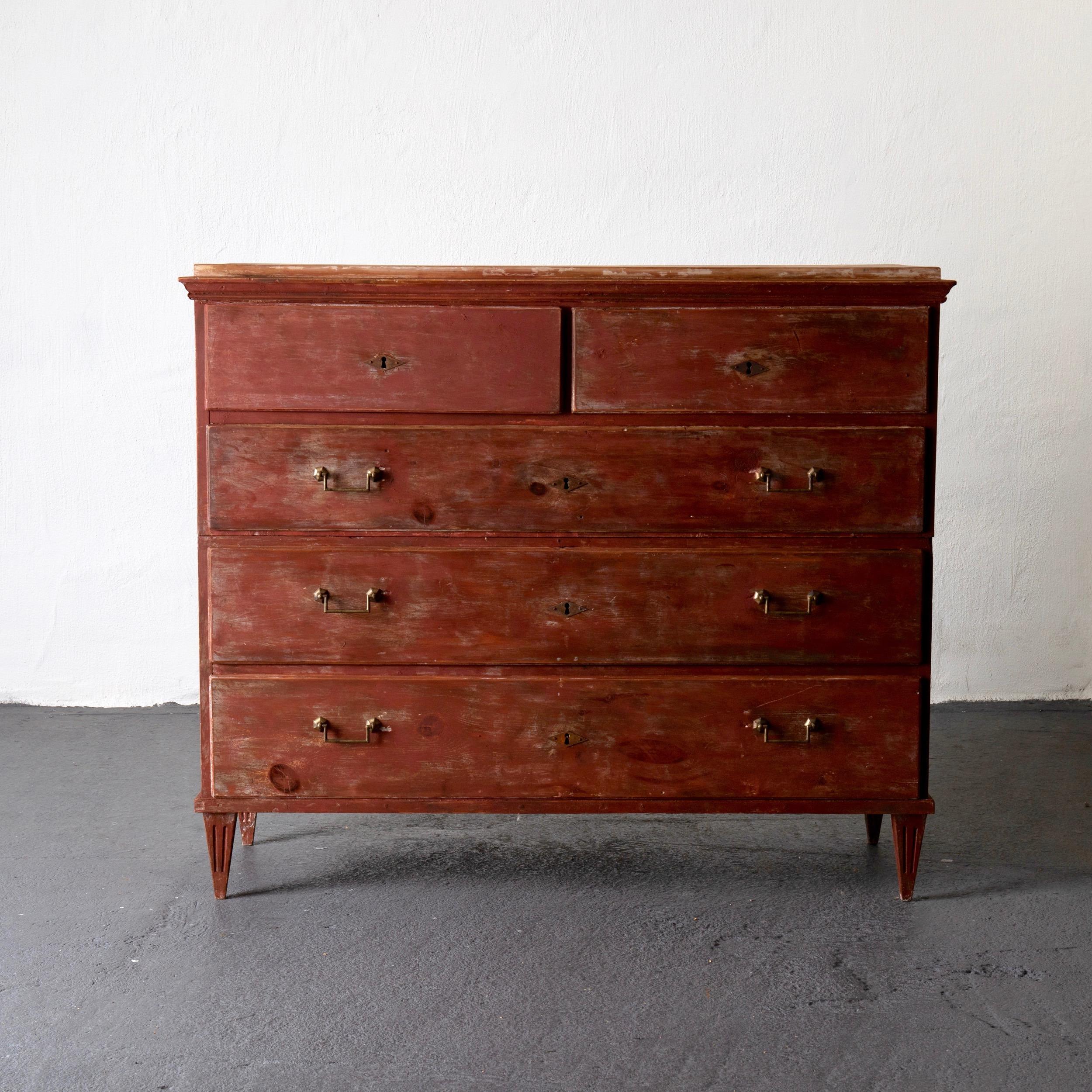 Chest of drawer dresser Gustavian Swedish red rustic, Sweden. A dresser made during the Gustavian period in Sweden. Painted in a reddish finish with a rustic look. Brass hardware. Tapered and channeled legs.