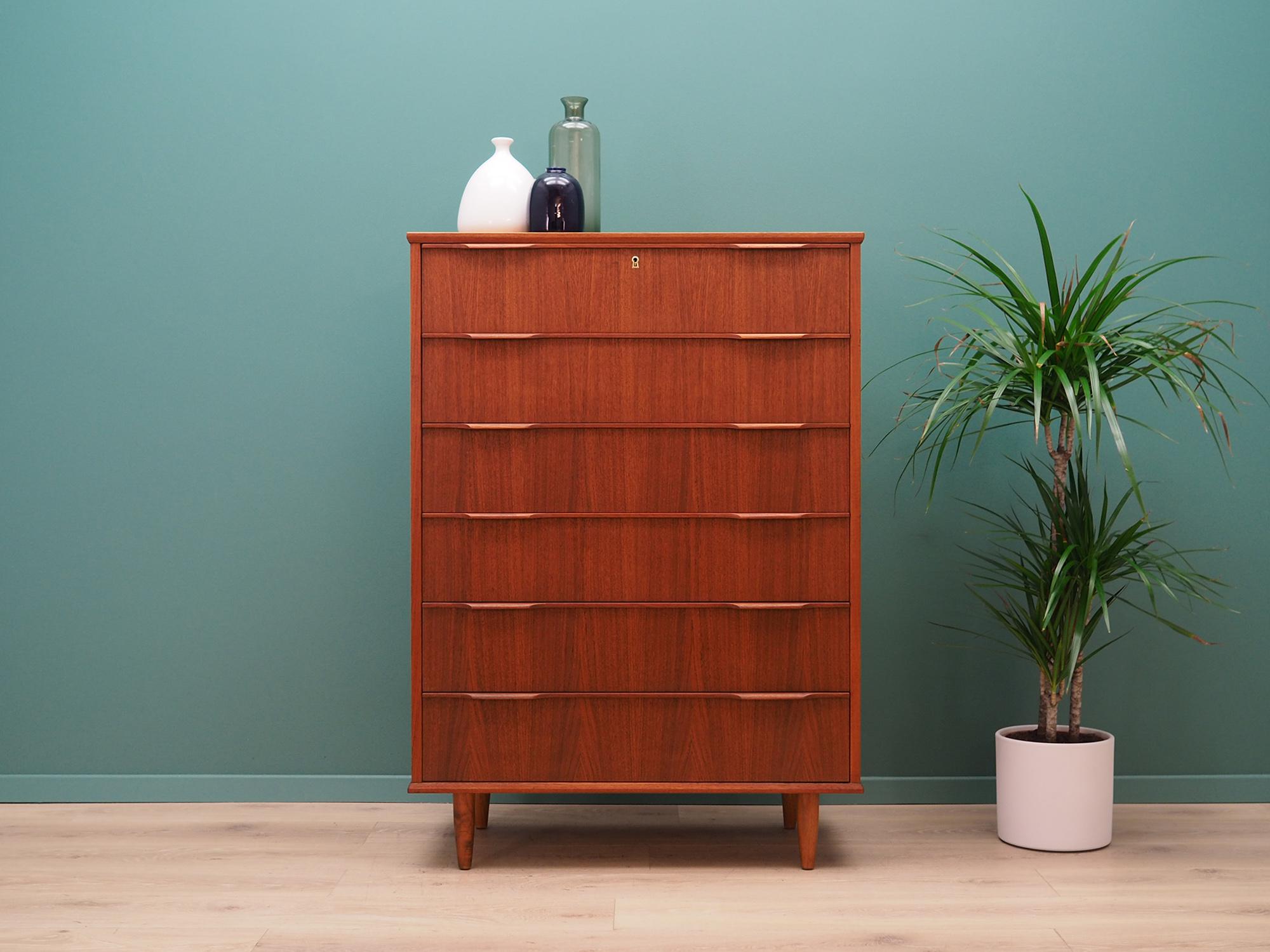 Brilliant chest of drawers from the 1960s-1970s . Scandinavian design, Minimalist form. The surface of the furniture finished with teak veneer. The chest of drawers has six packed drawers, no key in the set. Preserved in good condition (small