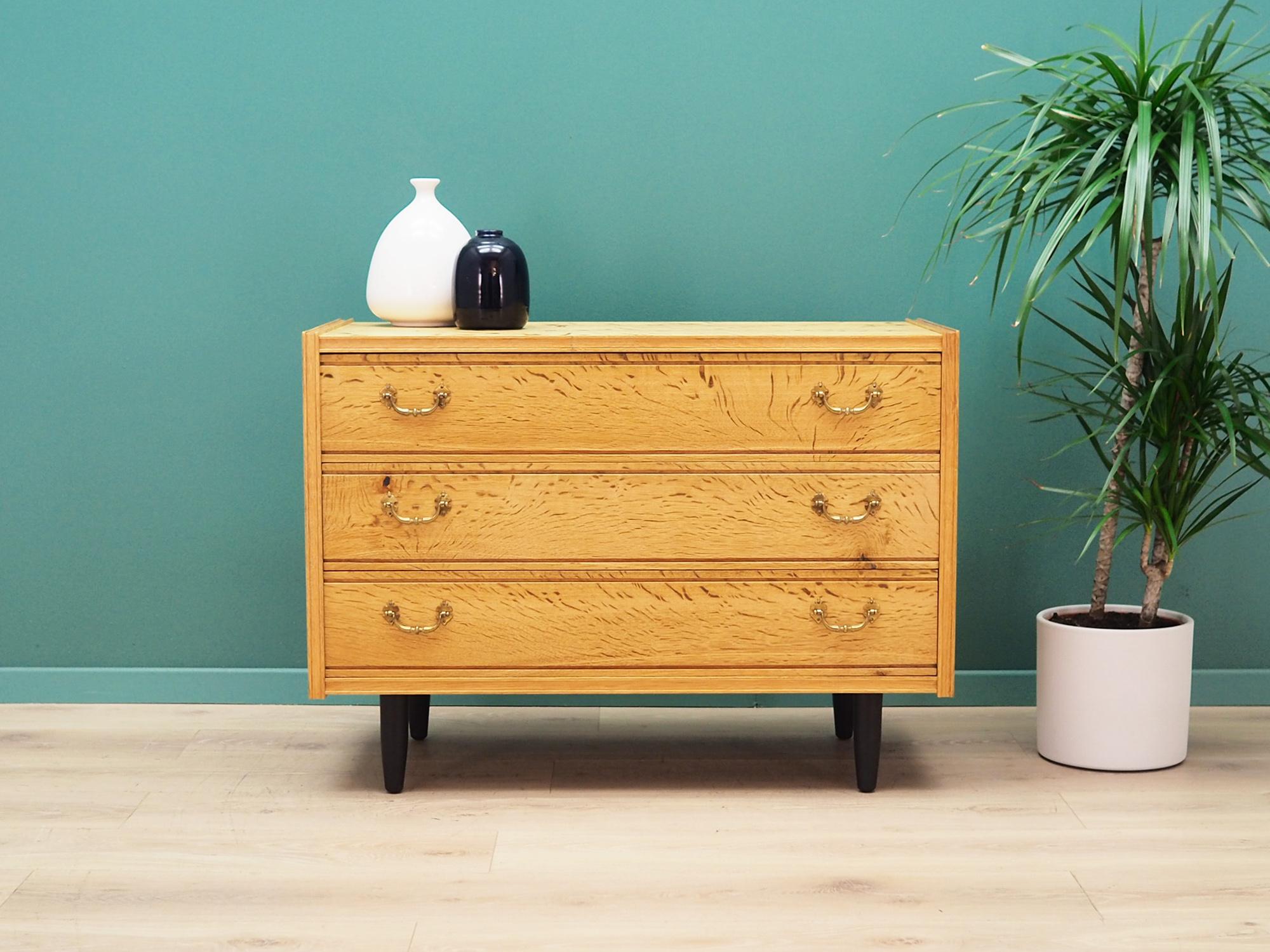 The chest of drawers was made in the 1960s, Danish production.

The construction is covered with ash veneer. Legs made of solid wood stained black. The surface after refreshing. The chest of drawers is a classic drawer, ideal for any space. Thanks