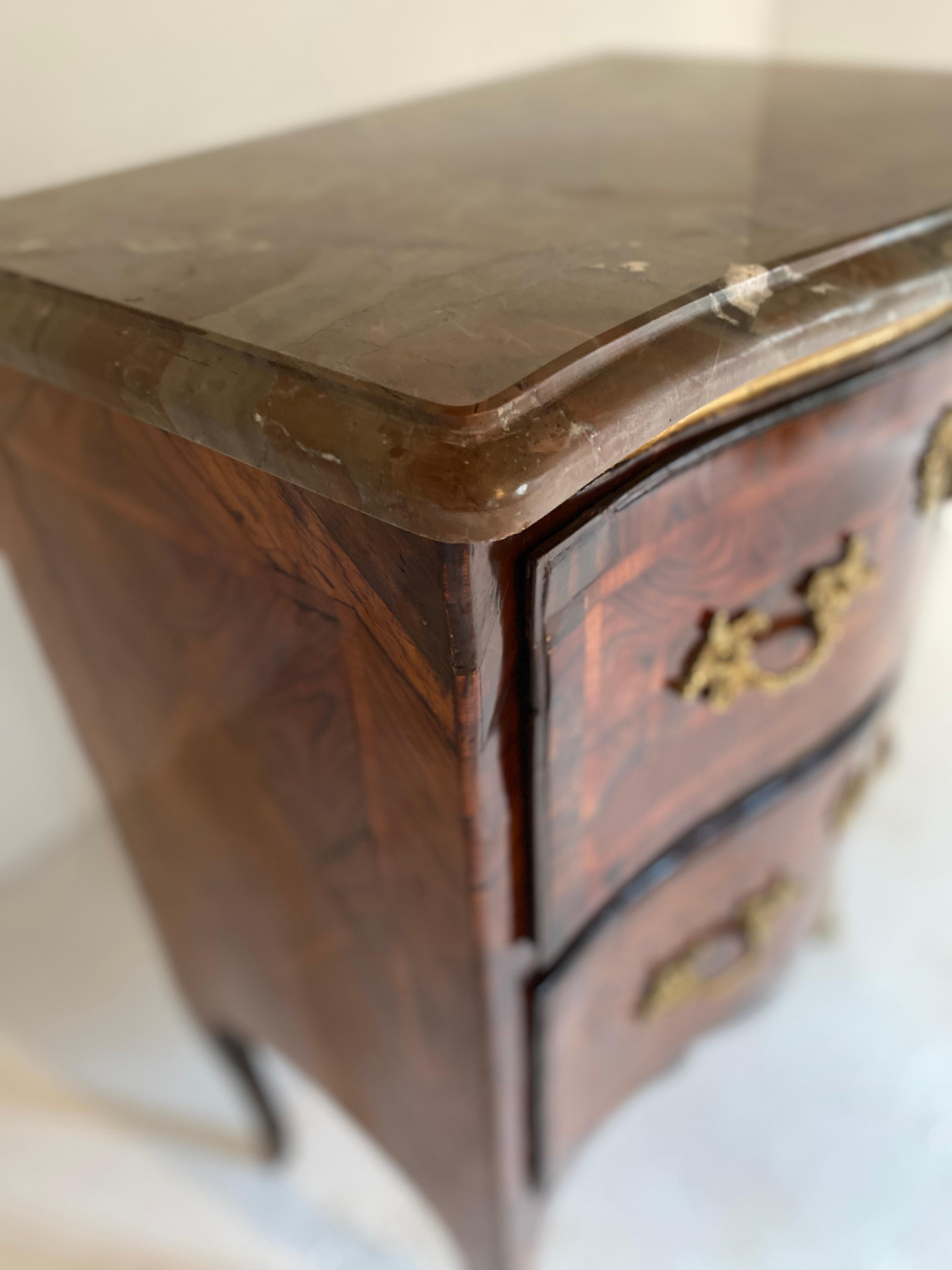 very pretty little chest of drawers sauteuse d'entre deux louis xv 18th century
 a marquetry of bramble and walnut original marble the bronzes are in perfect condition nice work of cabinetmaker
South France 
