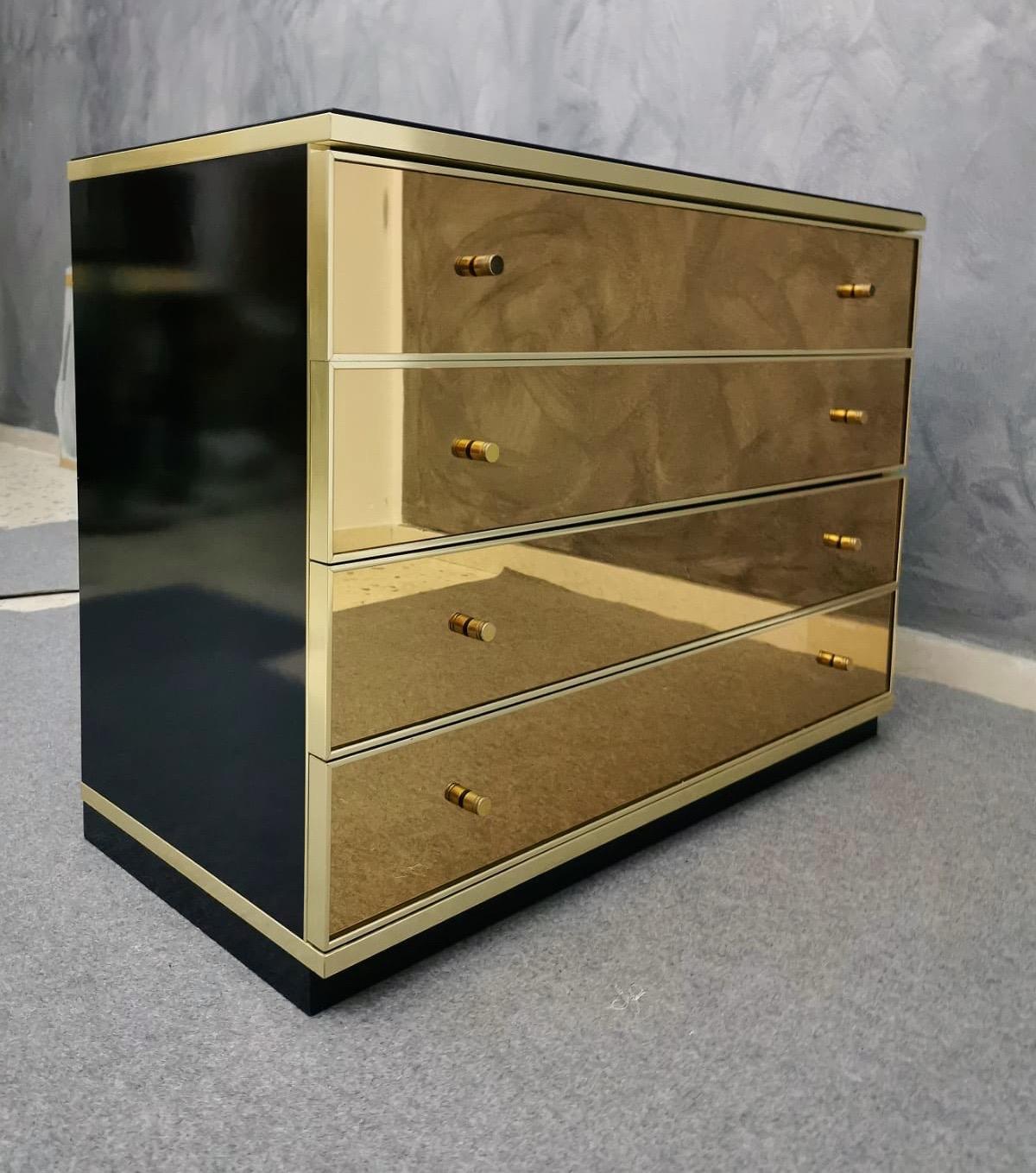 Chest of drawers commode or dresser by the designer Renato Zevi. Black lacquered wood, brass and goldish smoke mirror faces, black opaline glass top. Famous design like Willy Rizzo, Mario Sabot, Guy Lefèvre, Mahey, Maison Jansen.