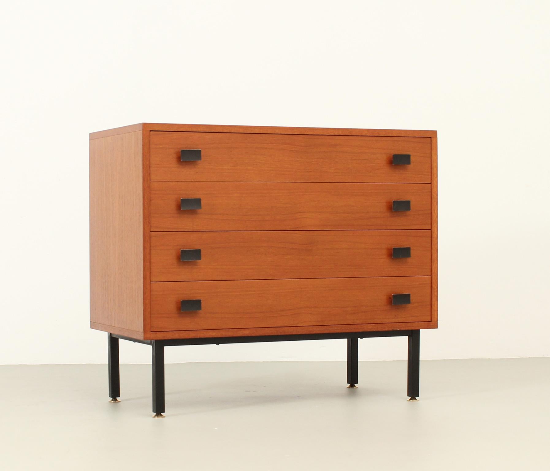 Chest of drawers designed by Antoine Philippon and Jacqueline Lecoq for Degorre, France, 1957. Teak wood with black metal base and handles and brass fittings. Four drawers.