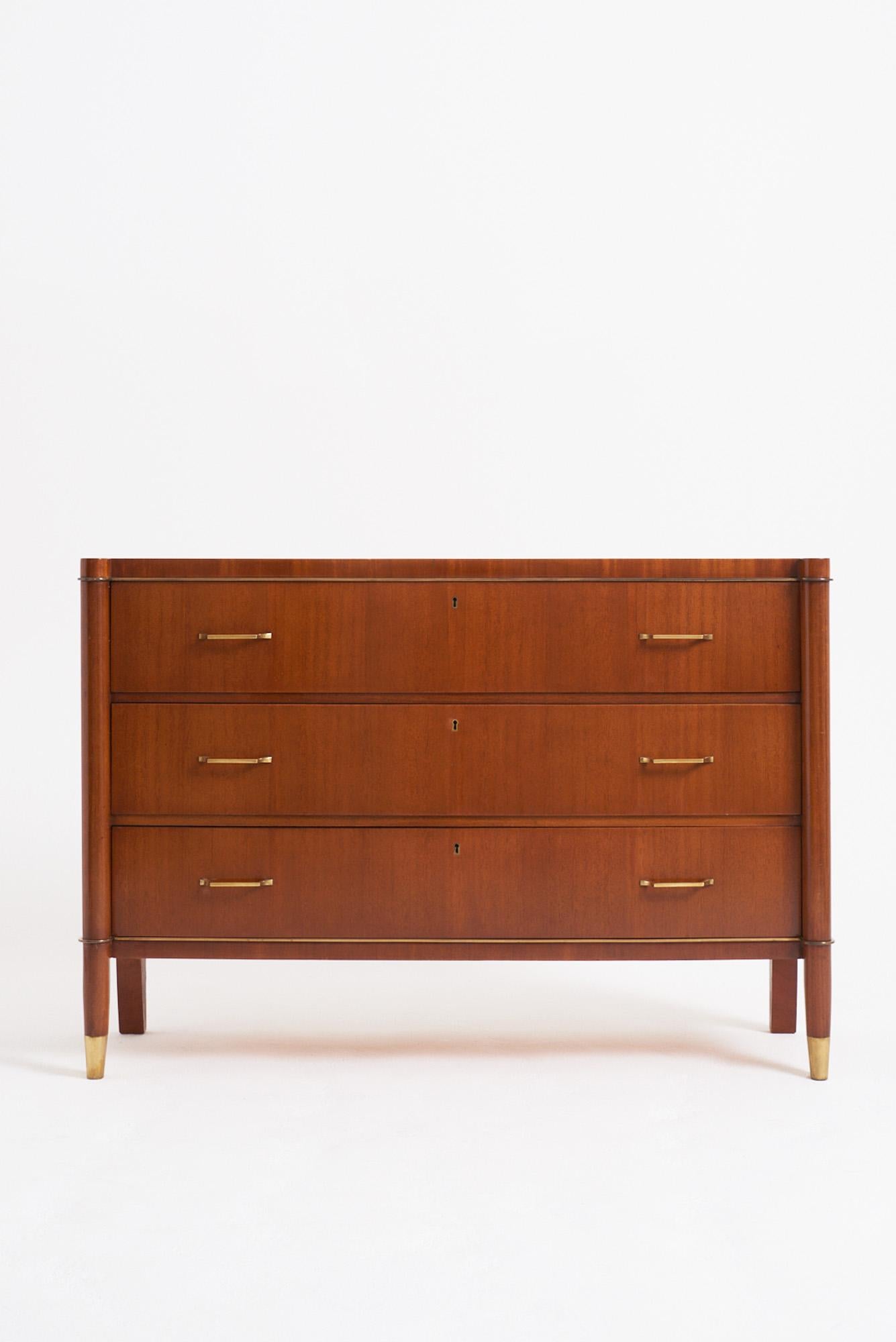 A mahogany and brass mounted chest of drawers by de Coene Frères.
Belgium, 1940s