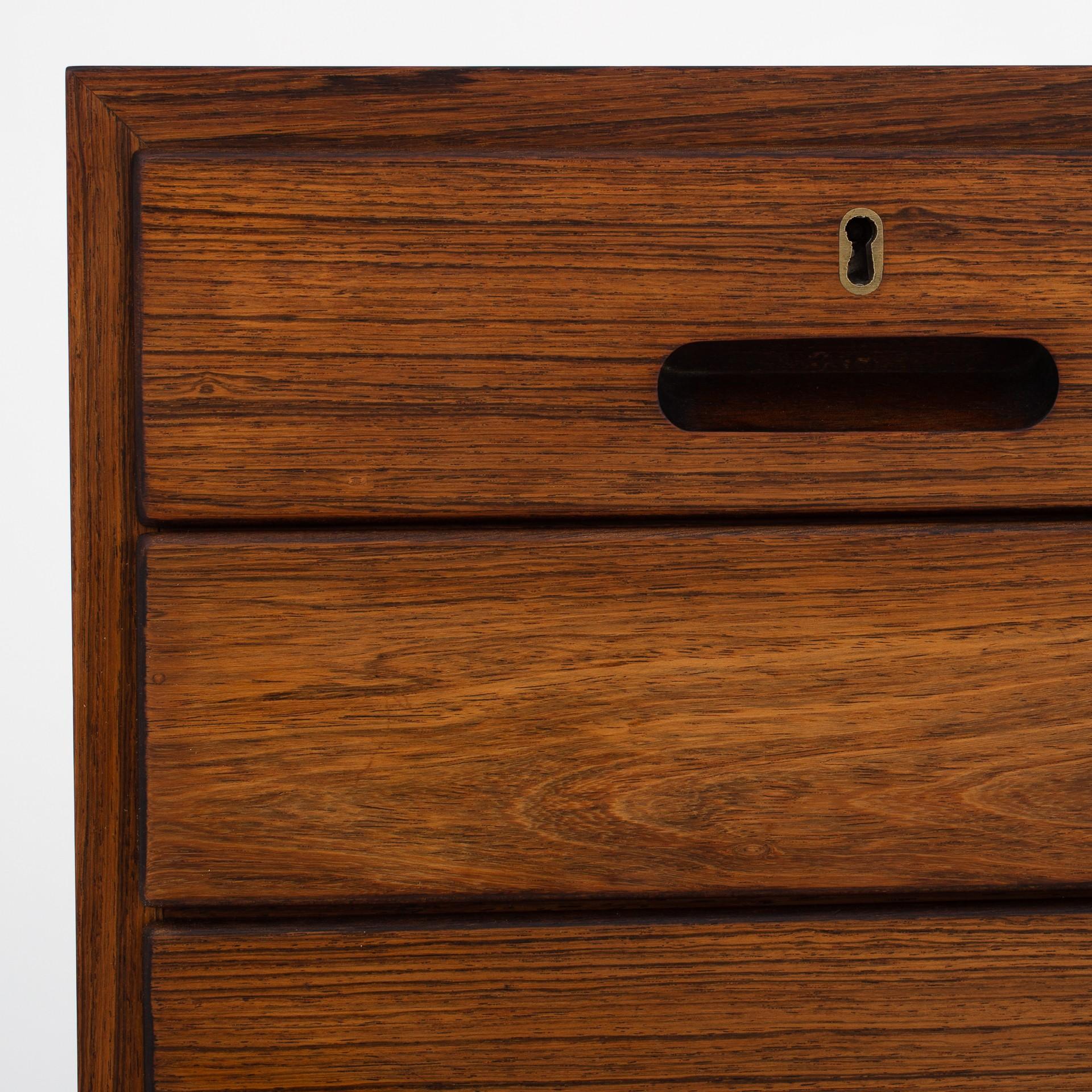 Chest of drawers in rosewood consisting of 8 drawers with brass key-holes. Maker P. Jeppesen.