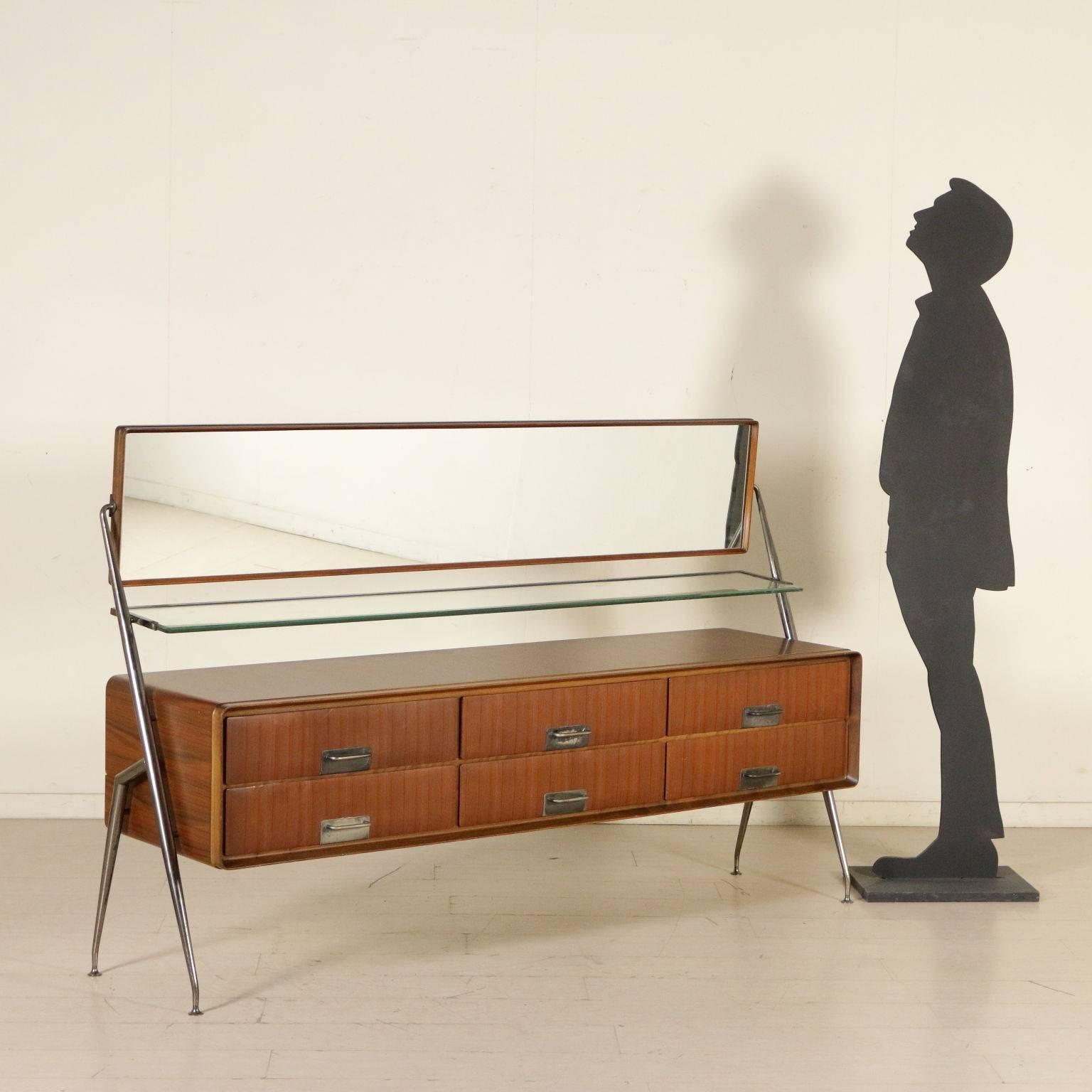 A chest of drawers with tilting mirror designed by Silvio Cavatorta. Glass shelf, teak veneer, burnished brass legs and inserts on the handles. Manufactured in Italy, 1960s.