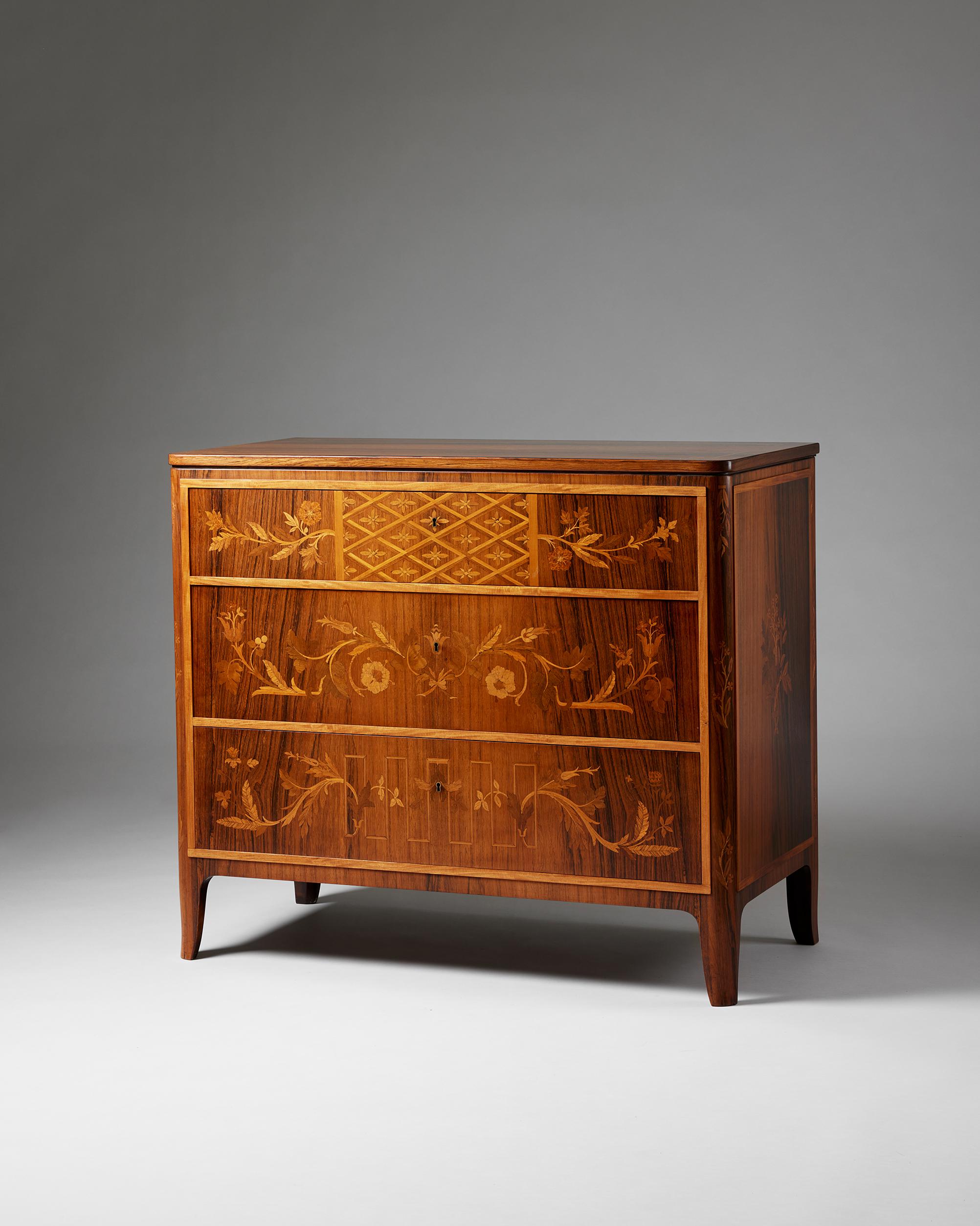 Chest of drawers designed by Carl Malmsten,
Sweden, 1930s.

Veneered mahogany, jacaranda, birch, and fruit trees.

Stamped.

Made by master carpenter Albin Johansson.

H: 87 cm
W: 100.5 cm 
D: 51.5 cm