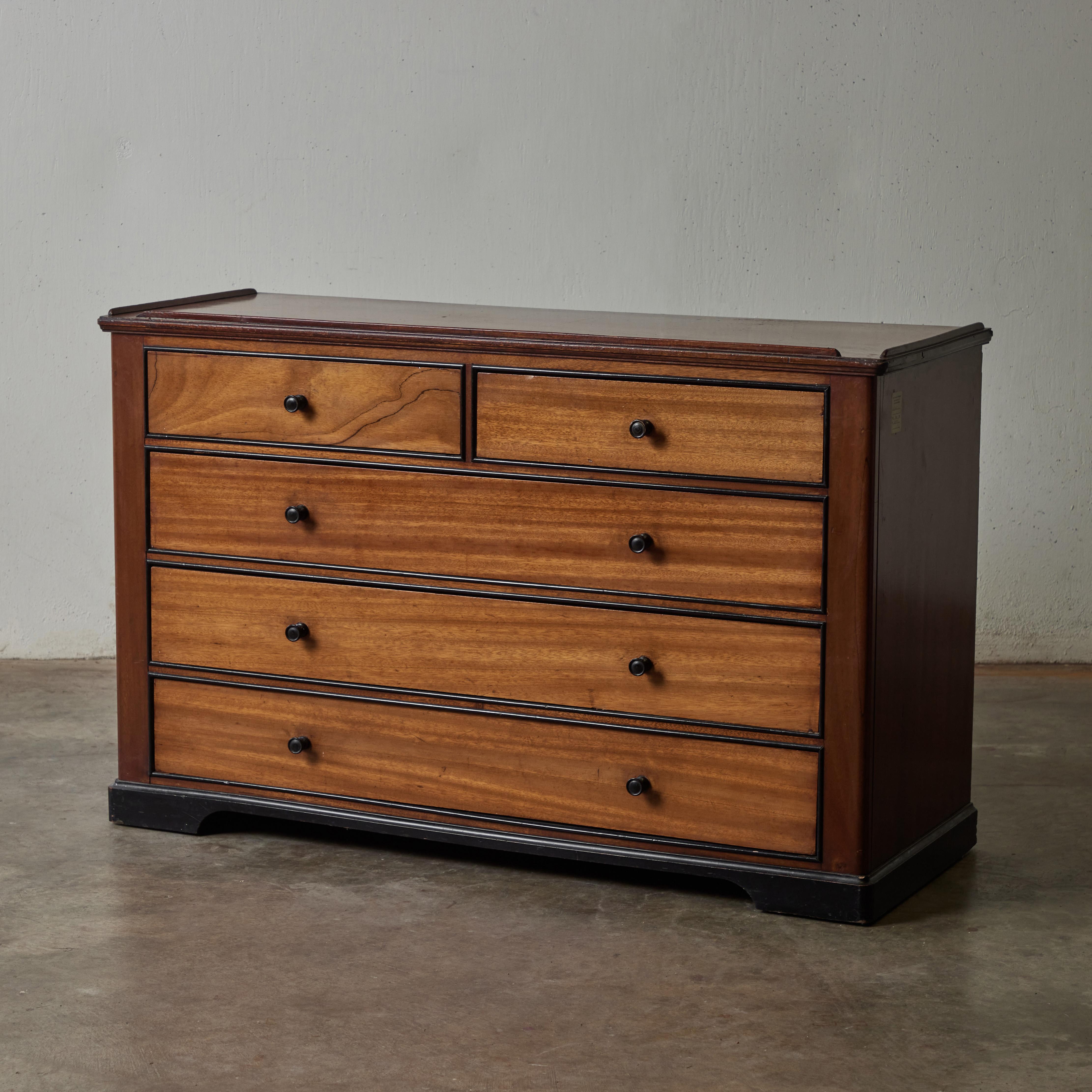 Mahogany chest of drawers with slim ebonized trim and round metal handles from the infamous White Star Line. The ill-fated shipping company was owners of both the Titanic and her sister ship, the Britannic, who went down in WWI. Well known for being