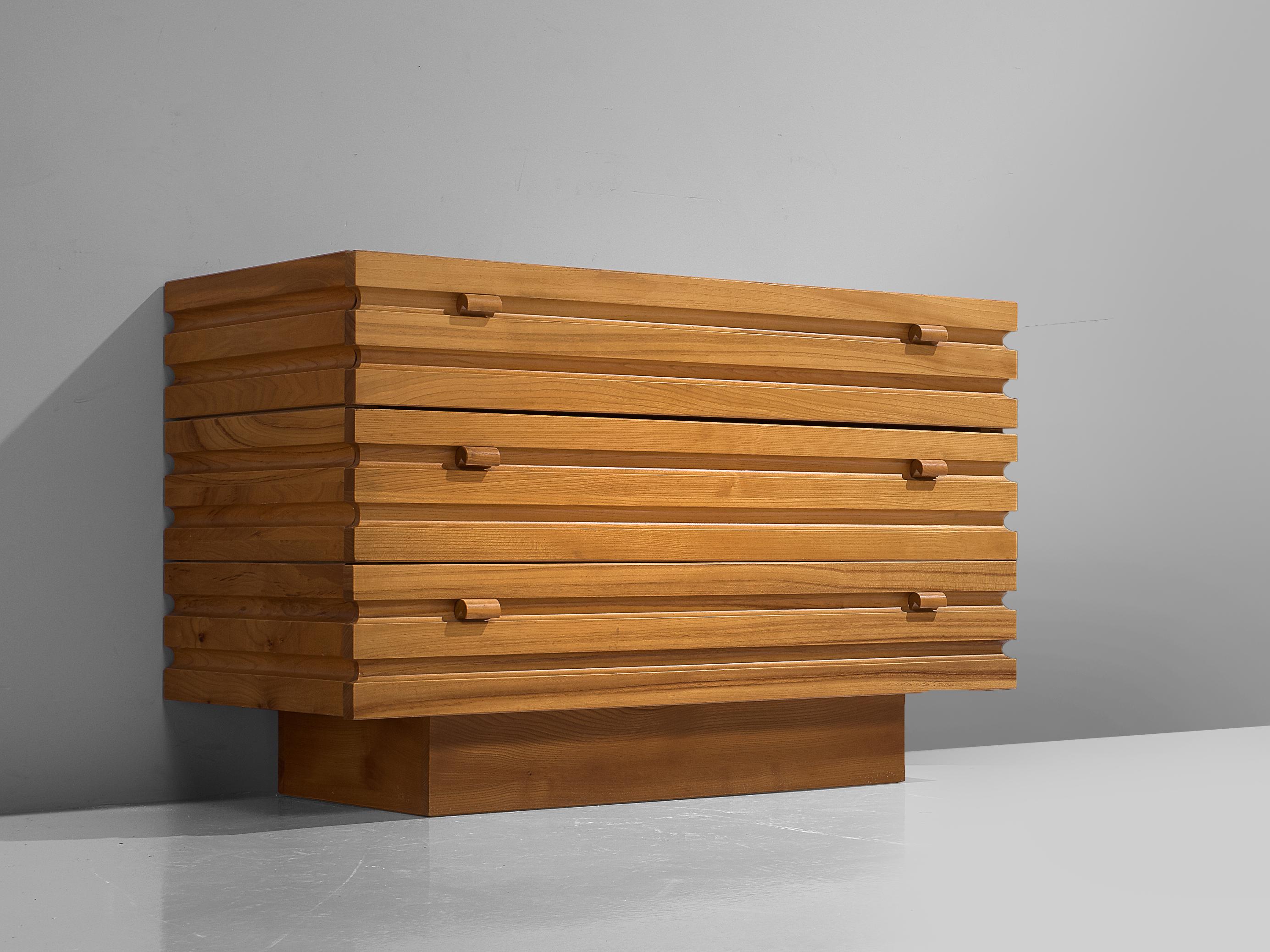 Maison Regain, sideboard, elm, France, 1970s 

One brutalist cabinet with three drawers. This simplistic designed sideboard has an exceptional graphical structure on the front and sides of horizontal lines. The craftsmanship is truly visible in