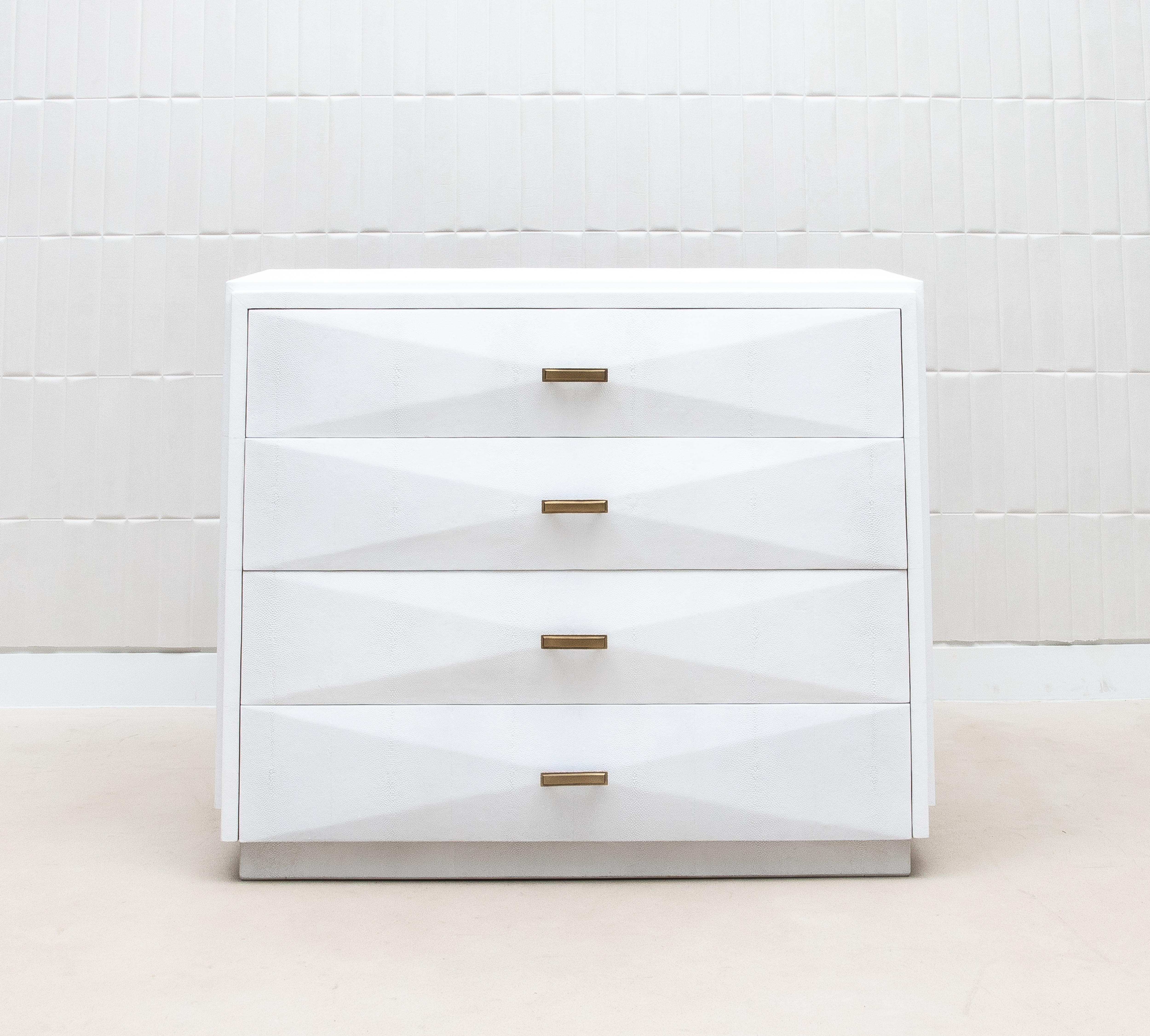 The Iconic Chest of Drawers by R&Y Augousti is a stunning example of luxury design, blending geometric precision with the opulence of fine materials. Crafted in pristine white shagreen, this chest exudes a sophisticated elegance, further enhanced by