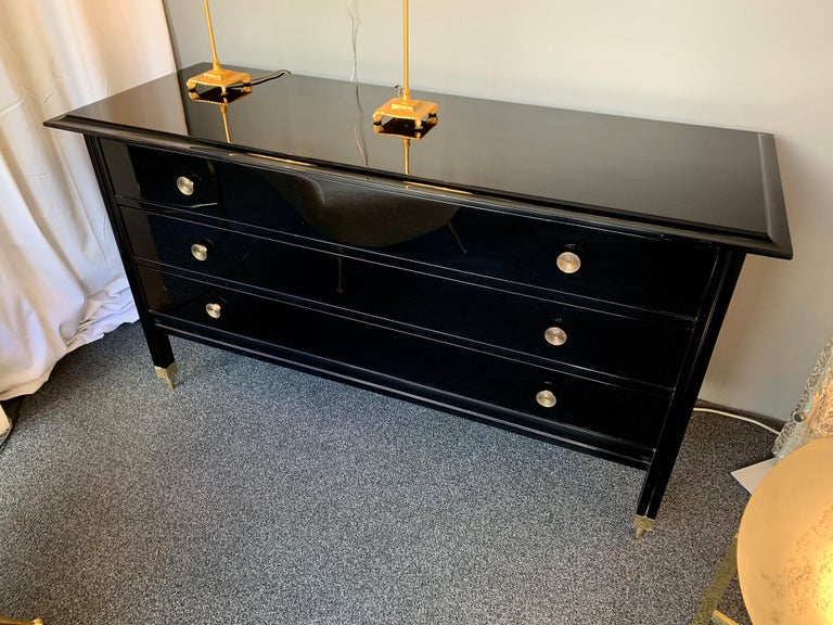 Dresser, chest of drawers or commode model D154, black lacquered, brass garniture elements by the designer Carlo de Carli for the editor Sormani 1964s. Very interesting feet characteristically of the model, in a neoclassical style inspiration.