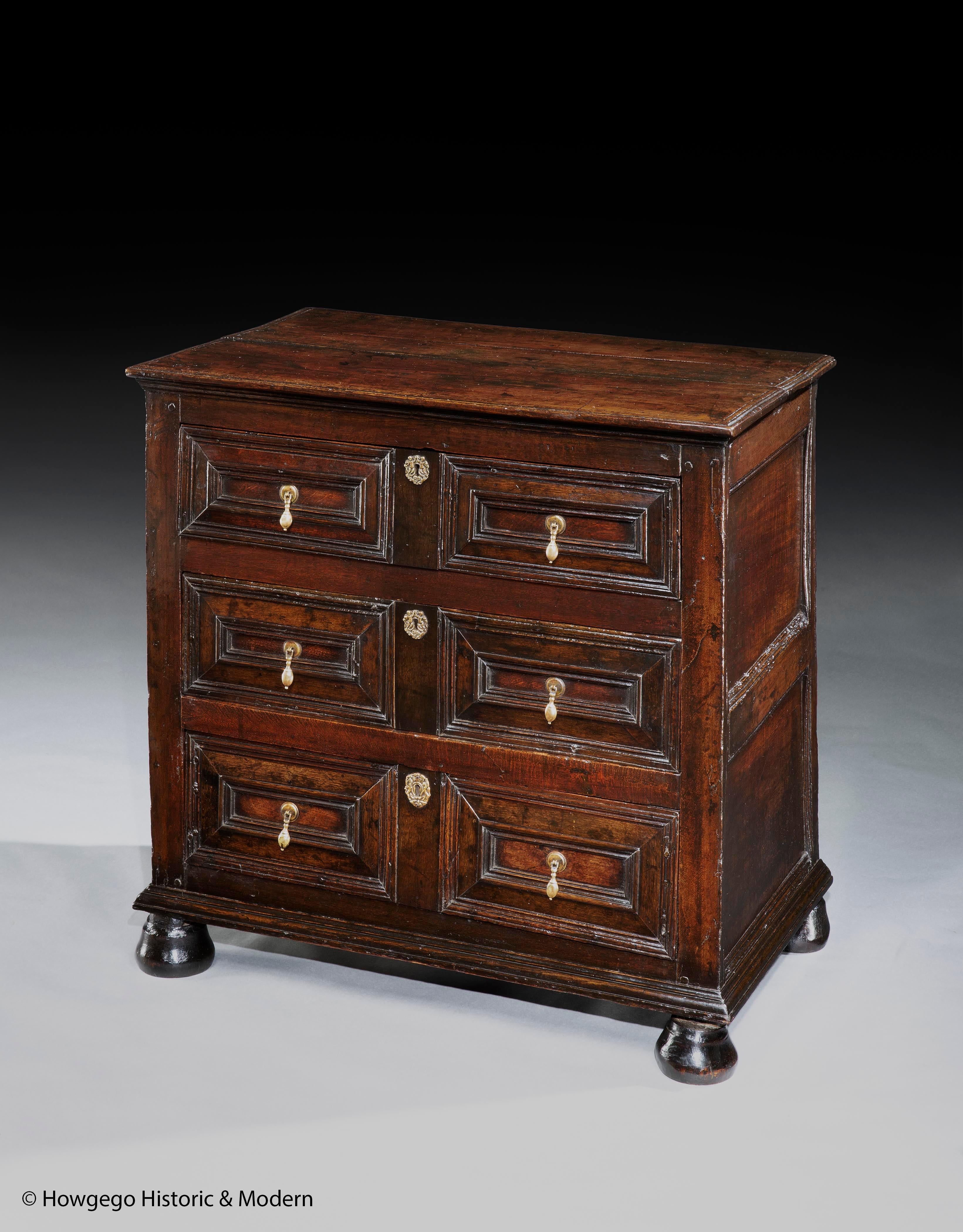 Lovely, characterful example of a good late-17th century oak chest of drawers with an exceptional lustrous and rich colour and patina.
The cushion moulded drawer fronts elevate this chest which has characteristic panelled sides, brasses and bun