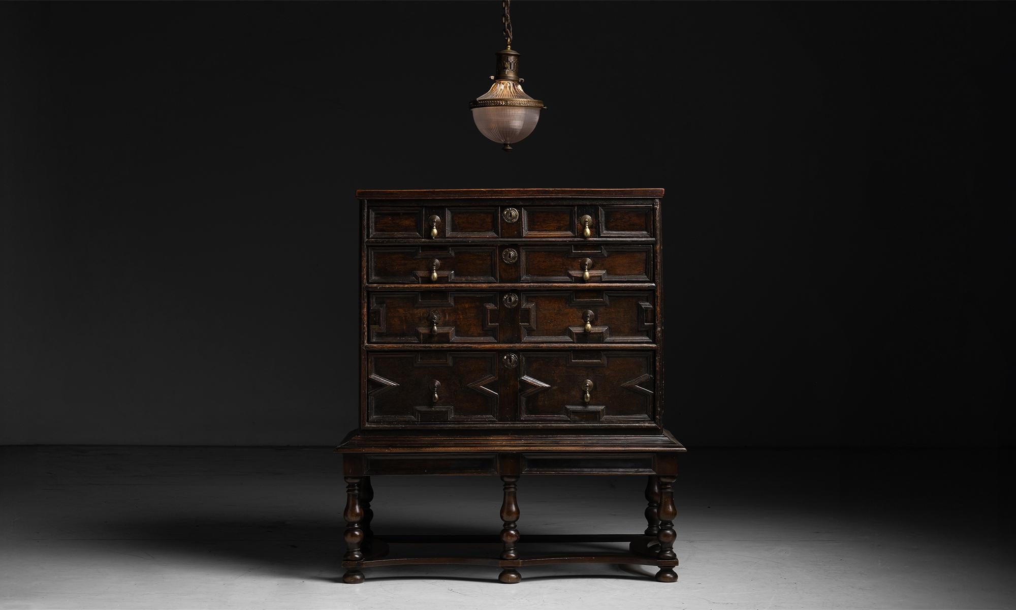 Chest of Drawers on Stand

England circa 1760

Constructed in oak, with geometric carved details, original brass pulls, on turned leg stand.

45.75”w x 25”d x 51.5”h