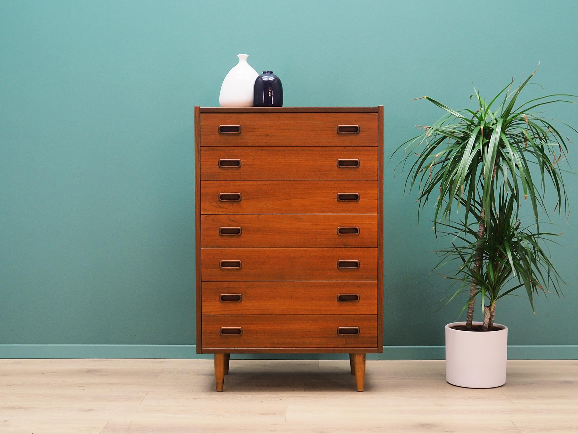 Superb chest of drawers from the 1960s-1970s. Scandinavian design, minimalist form. The surface of the furniture finished with teak veneer. The chest has seven packed drawers. Preserved in good condition (small bruises and scratches, filled with