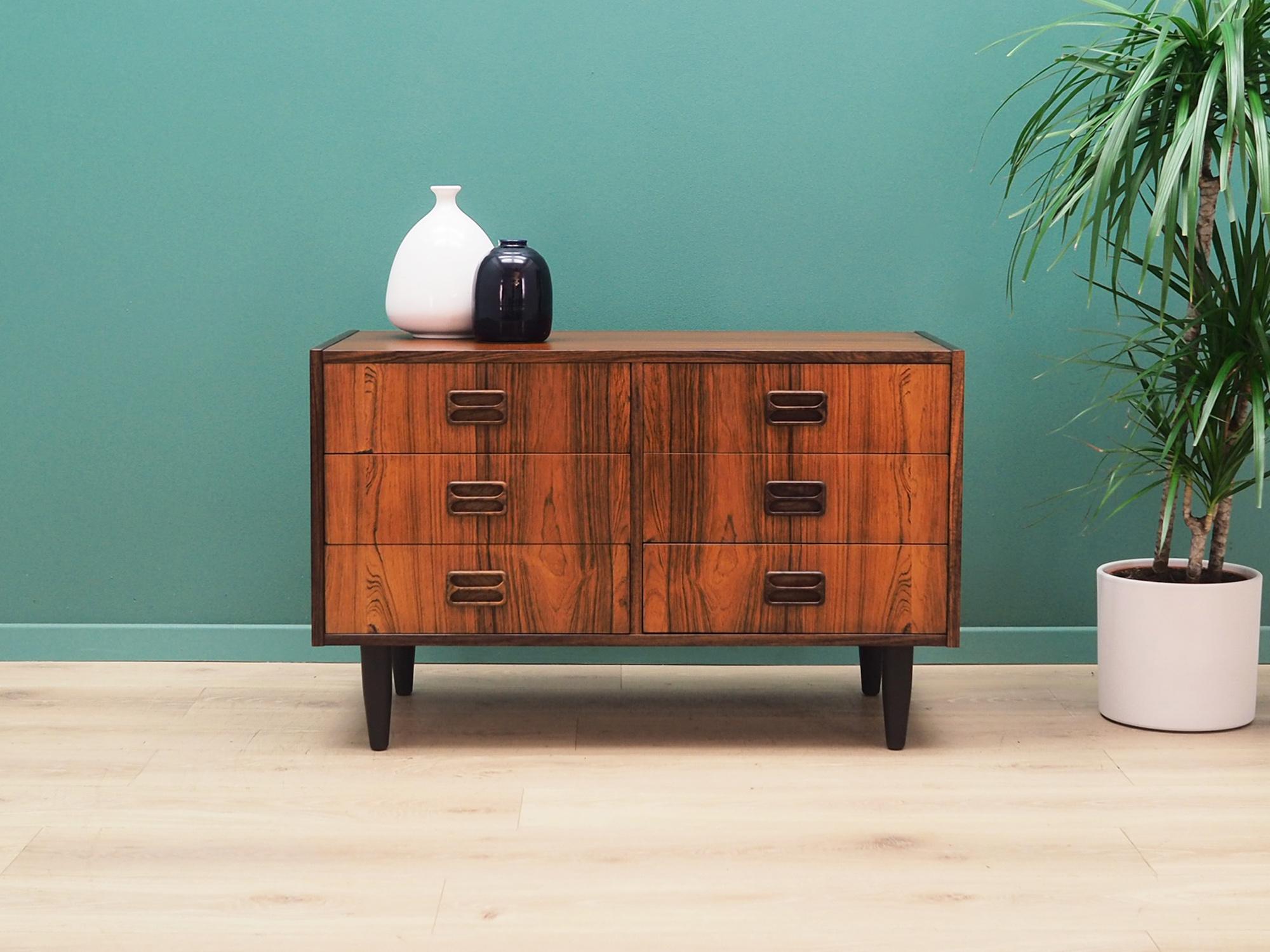 Chest of drawers was made in the 1970s and was designed by leading Danish designer Niels J. Thørso.

Structure is covered with rosewood veneer. Legs are made of solid wood and stained black. Surface after refreshing. This piece of furniture is a