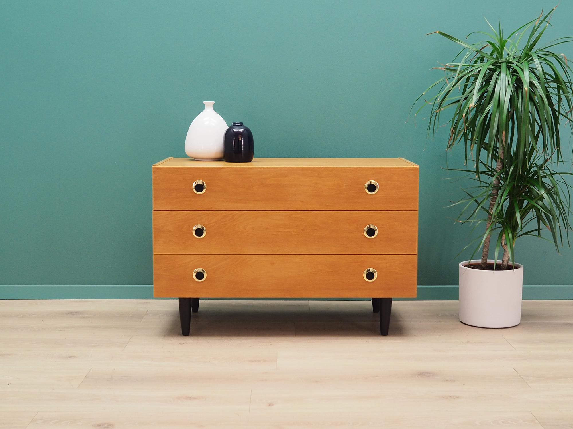 Original chest of drawers from the 1960s-1970s. Danish design, minimalist form. The furniture is covered with ash veneer. The chest of drawers has three spacious drawers. Preserved in good condition (small bruises and scratches), directly for