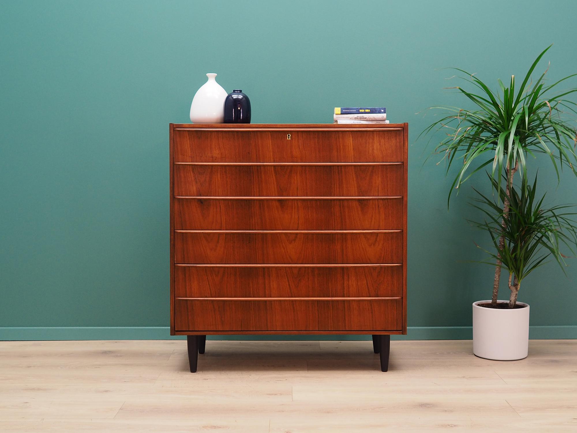 Fantastic chest of drawers from the 1960s-1970s. Scandinavian design, Minimalist form. The furniture is covered with teak veneer, legs are made of solid teak wood. The chest has six spacious drawers, no key included. Preserved in good condition