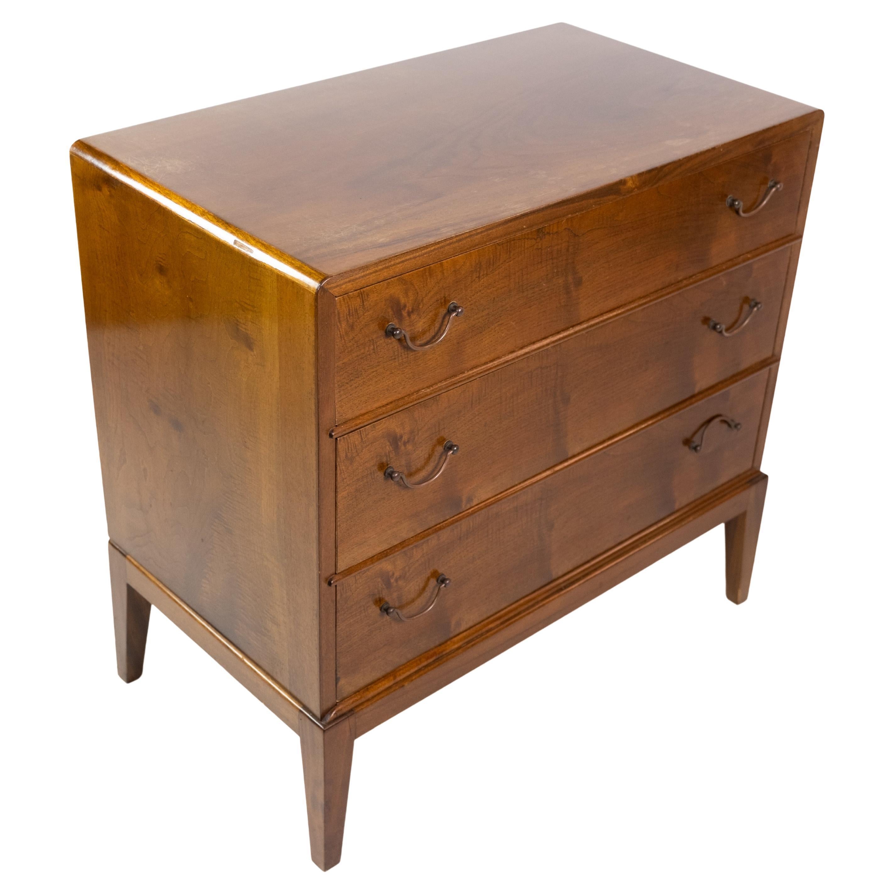 Small chest of drawers in walnut with brass handles and 3 drawers in Danish design from the 1960s.

This product will be inspected thoroughly at our professional workshop by our educated employees, who assure the product quality.