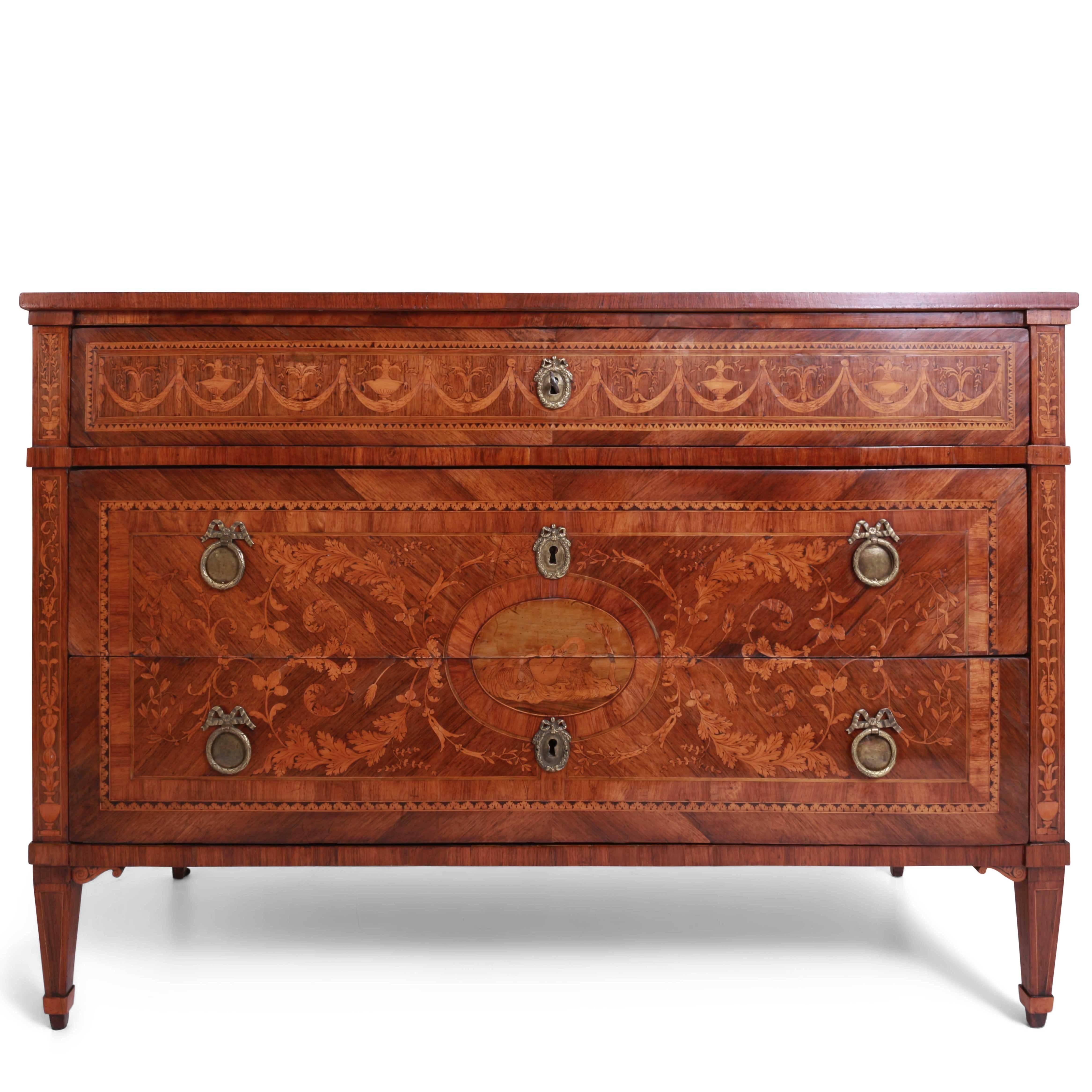 Three-drawered Louis Seize Chest of Drawers on tapered legs, attributed to the Italian Maestro Giuseppe Maggiolini (1738-1814). The typically streamlined chest shows Fine marquetry on the drawers and the sides. The front shows a medallion surrounded