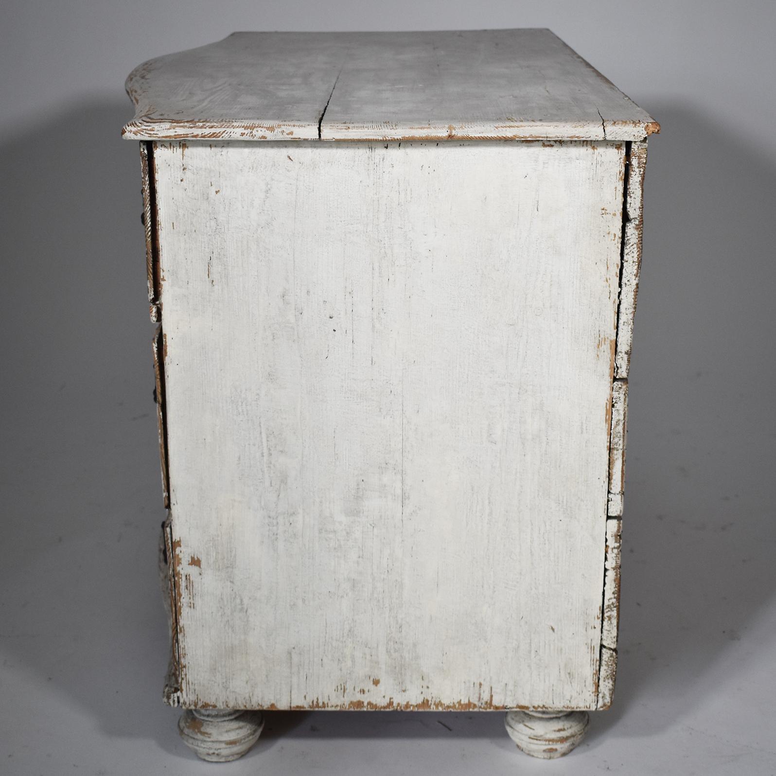 This charming 19th-century Swedish three-drawer chest is a wonderful combination of form and simplicity. Made of pine with a white painted finish scraped to the original patina and brass hardware on turned bun feet. Perfect for bedside or in any