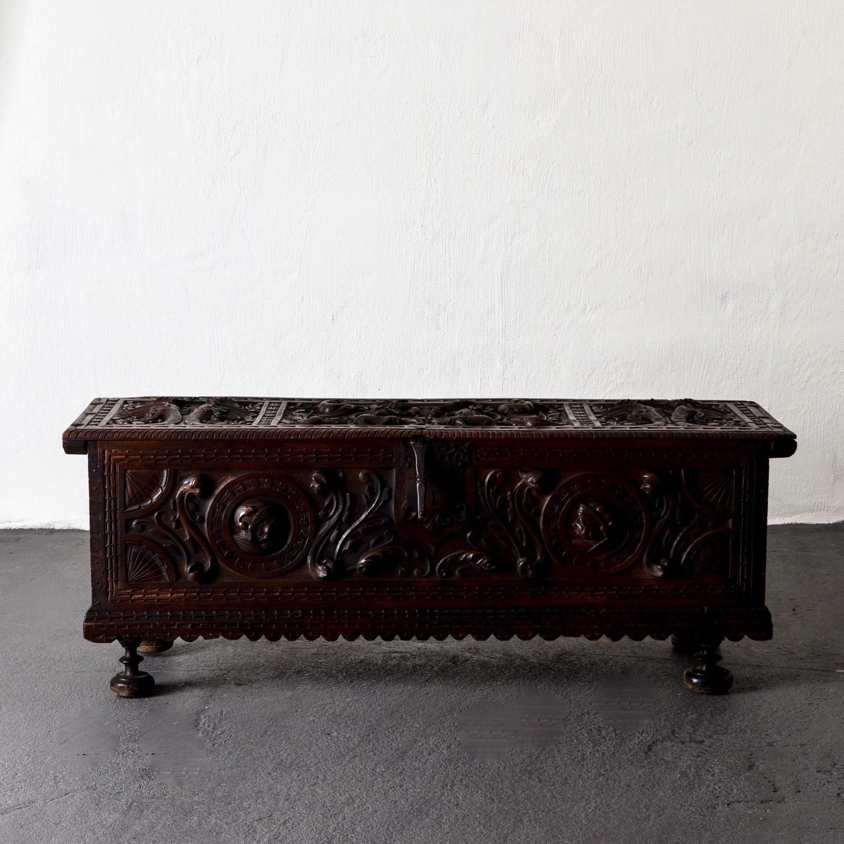 A chest made during the Baroque period in the southern part of Europe, most likely Italian. Made from stained and waxed oak. Richly carved with stunning motifs. Original hardware.


   