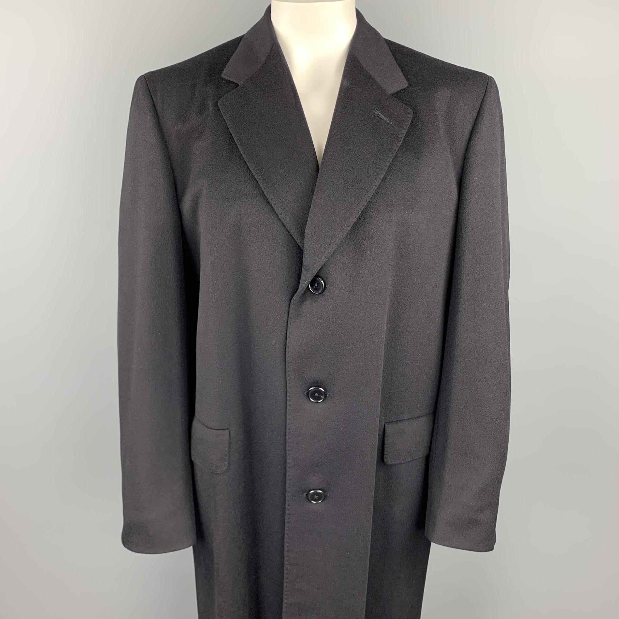 CHESTER BARRIE coat comes in a black cashmere featuring a notch lapel style, flap pockets, and a buttoned closure. Made in England. 

Very Good Pre-Owned Condition.
Marked: 42 L

Measurements:

Shoulder: 19 in. 
Chest: 42 in.
Sleeve: 27.5 in.