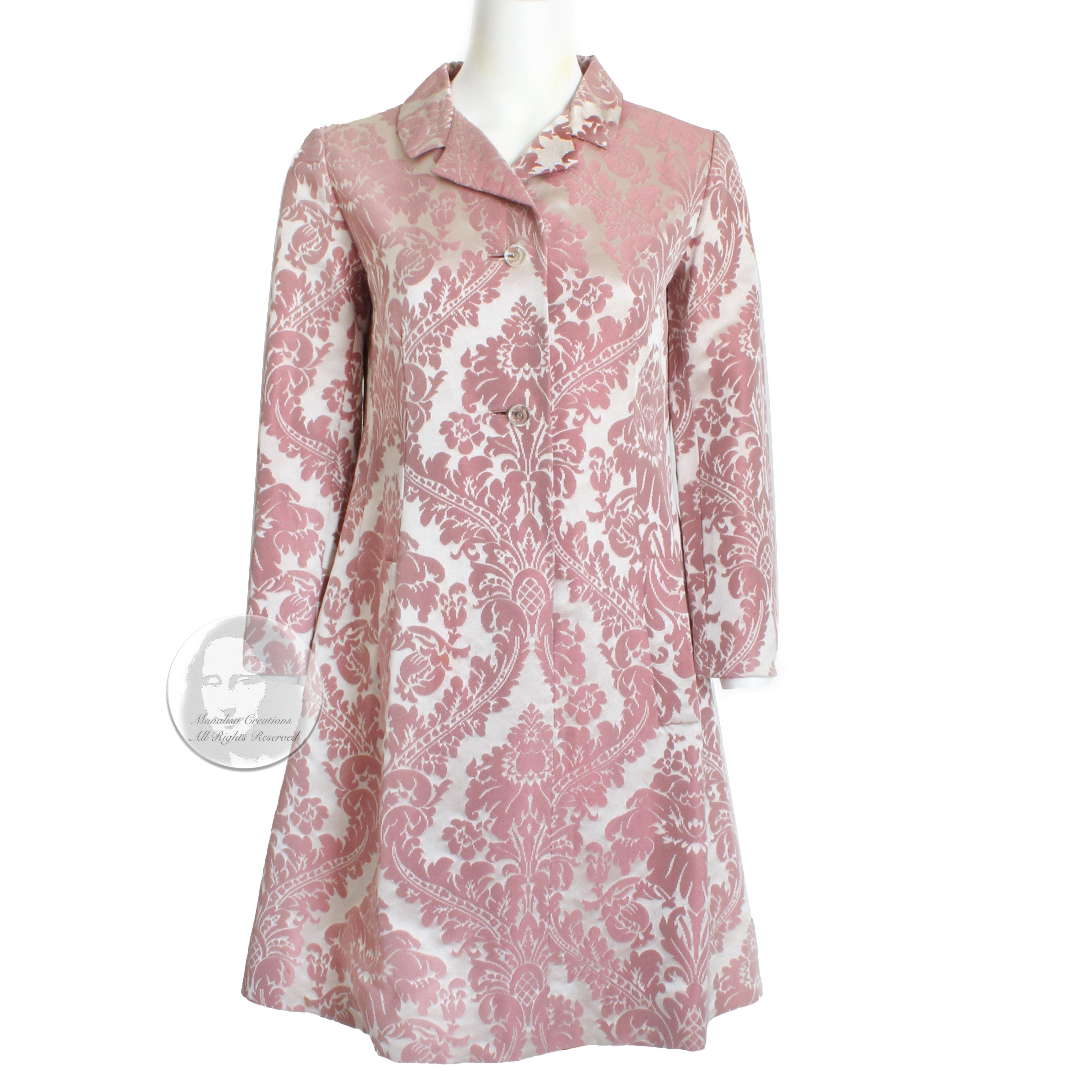 This fabulous coat dress was made by Chester Weinberg and sold by the Oval Room at Daytons, most likely in the mid 60s.   Made from a gorgeous pink floral damask, it has an incredible sheen to the fabric! It slips over the head and fastens with