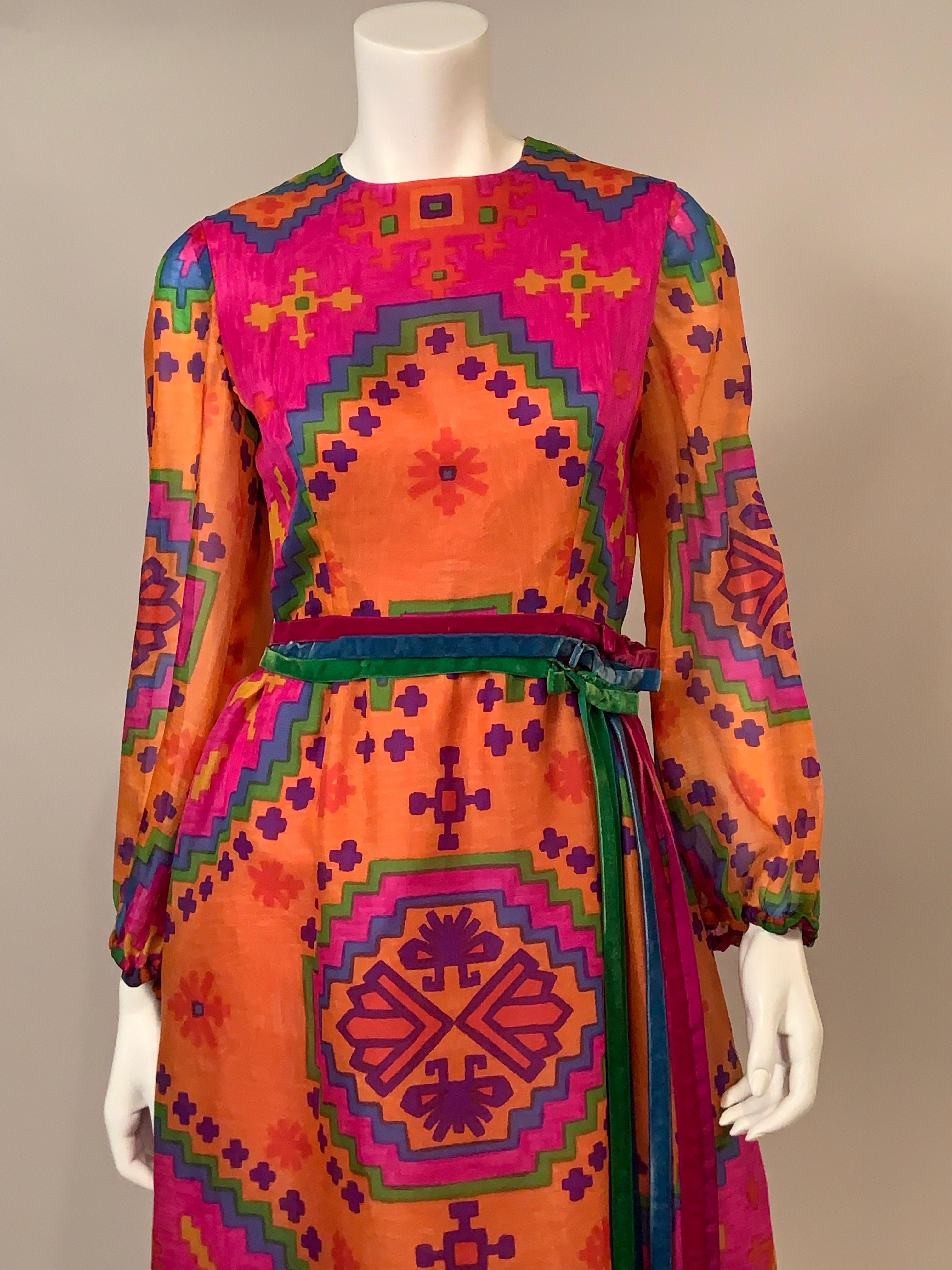 Chester Weinberg was a contemporary of Oscar de la Renta, Bill Blass and Geoffrey Beene and a recipient of The Coty Award in 1970.  This colorful silk organza print dress is a great example of his work.  The ethnic inspired print dress in hot pink,