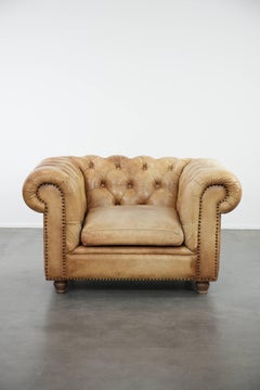Chesterfield armchair made of cowhide leather in a light cognac colour
