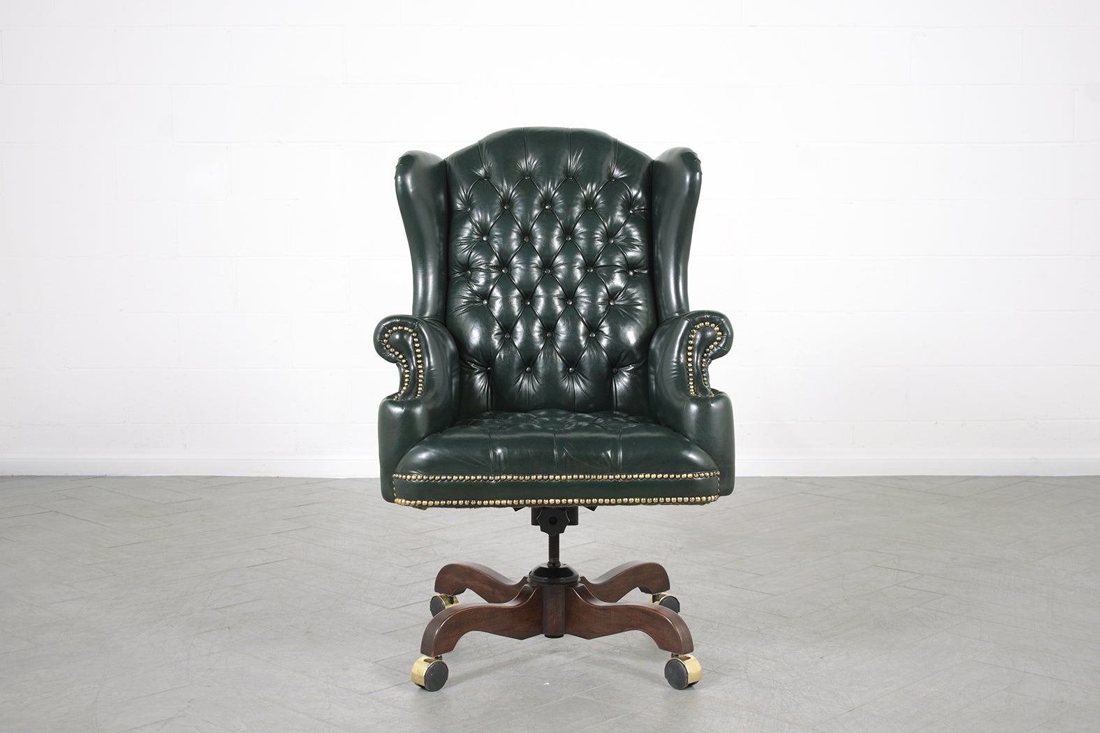 An extraordinary executive leather wingback chair is in great condition and has been completely restored by our professional craftsman team in the house this 1970s office chair is hand-crafted out of a wood and leather combination this fabulous