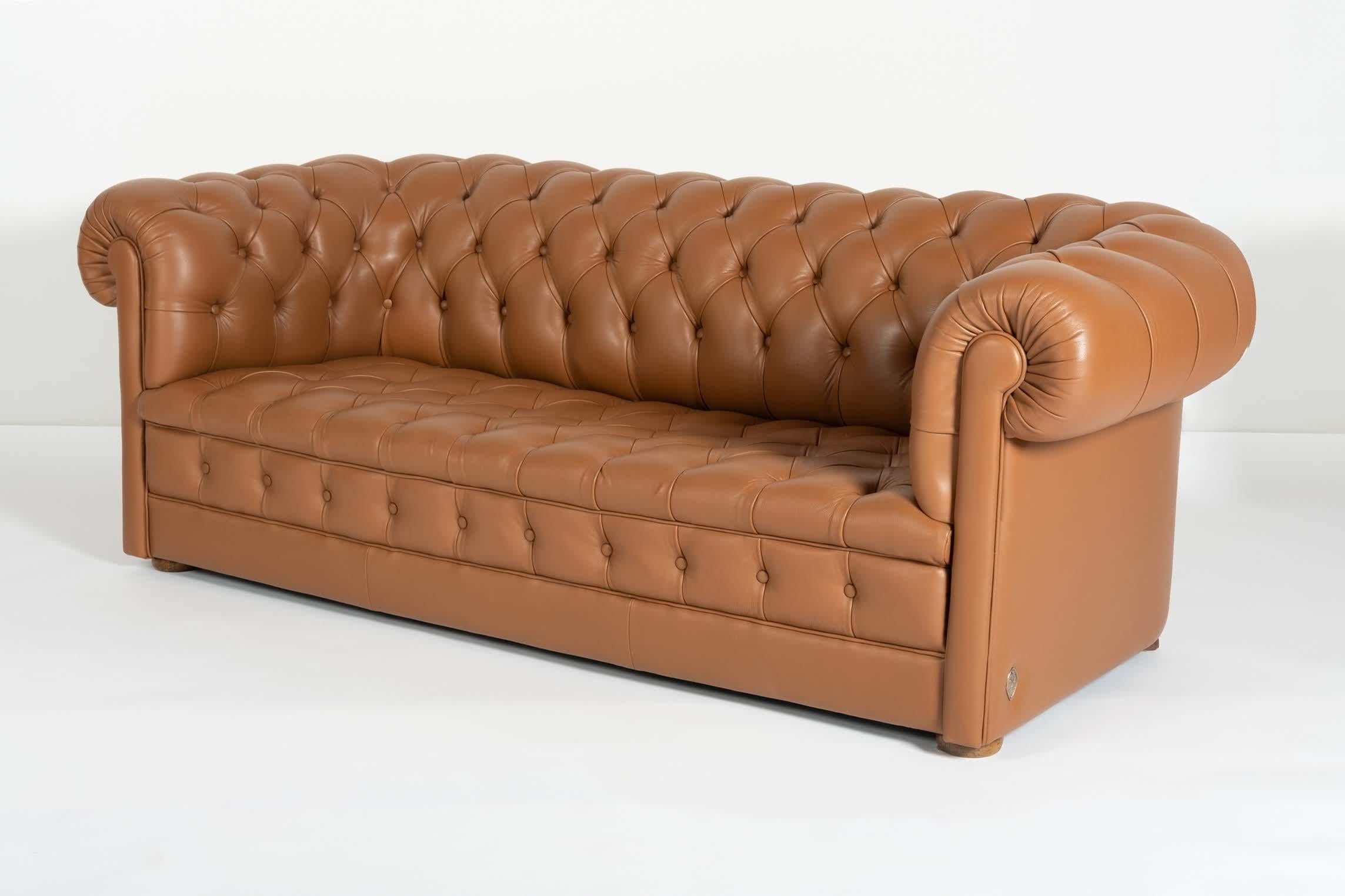 This set includes one sofa and two armchairs. It has been completely reupholstered by Italian artisans in fine leather.