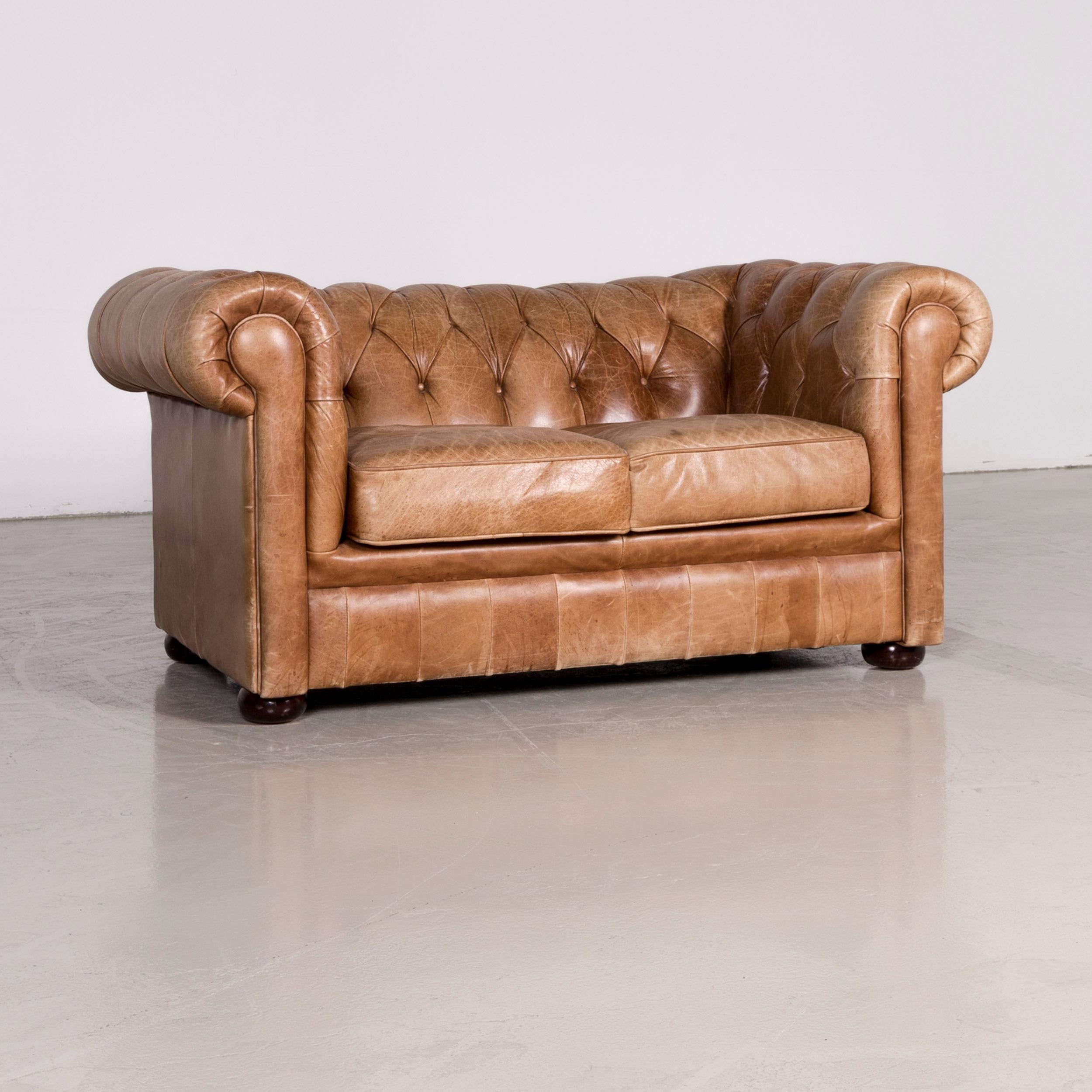 We bring to you a Chesterfield leather sofa brown red vintage two-seat couch.